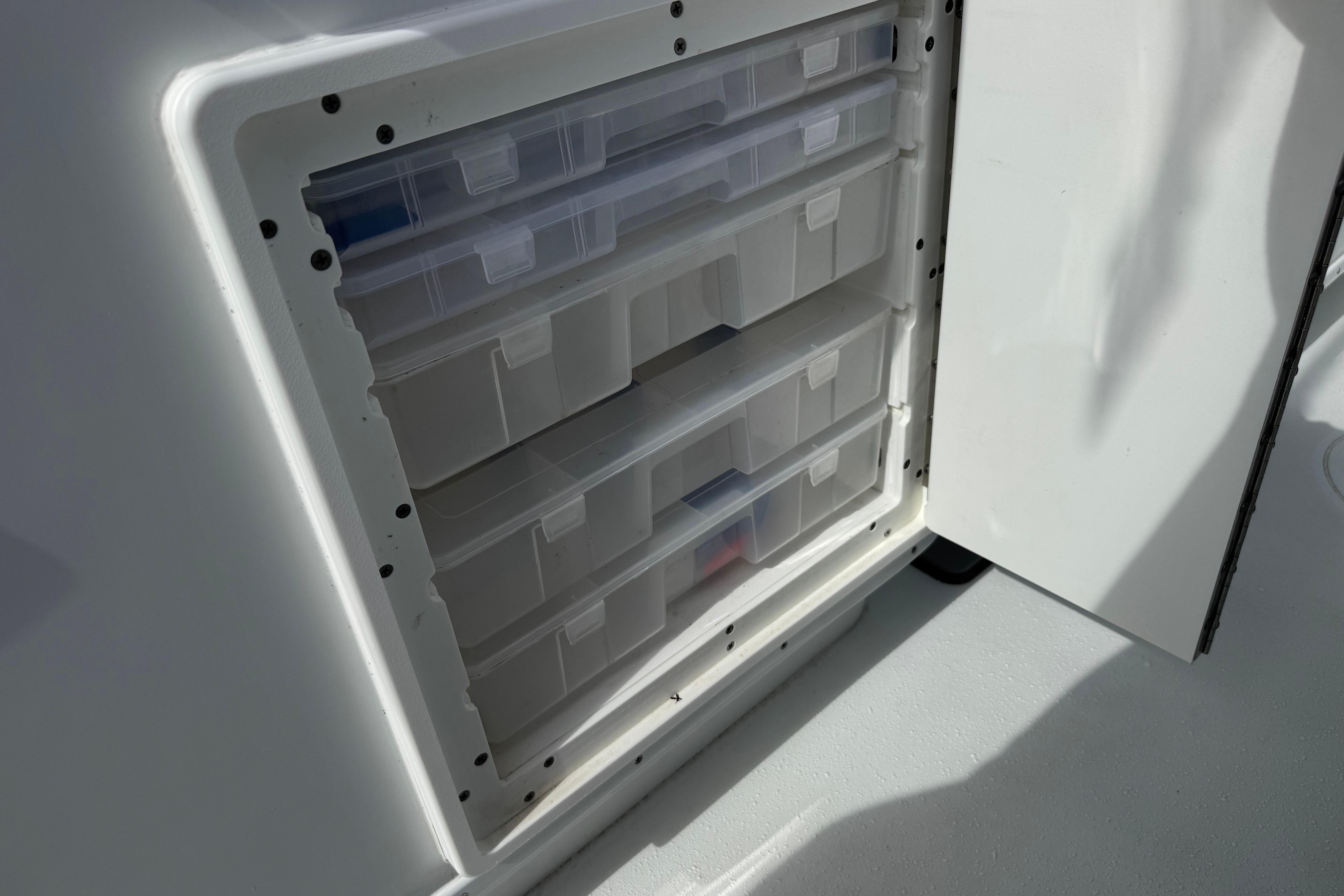 Storage compartment with clear plastic drawers on a 2022 Yellowfin 32 Offshore boat.