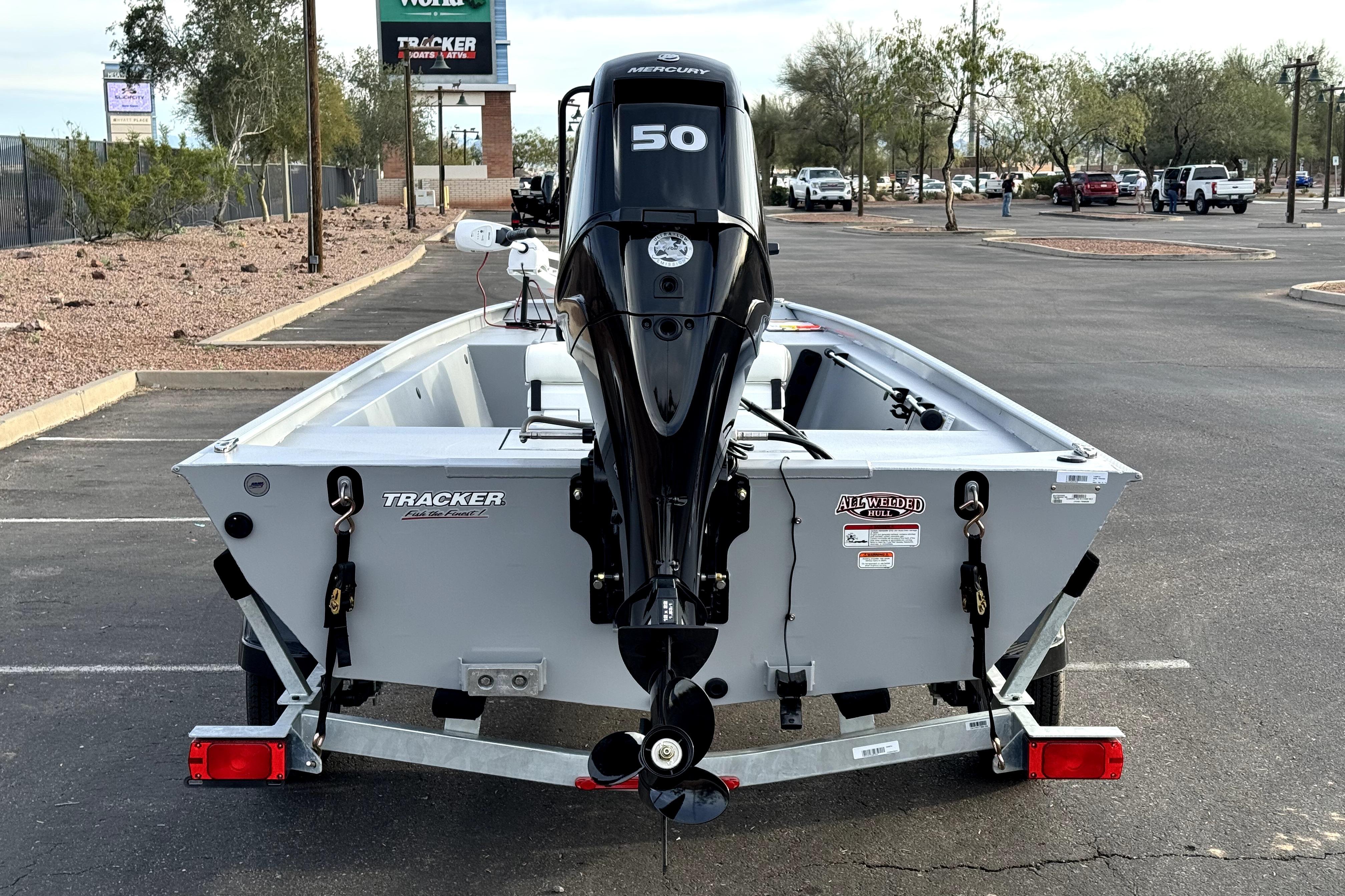 2026 Tracker Bass Tracker Classic CC boat with Mercury 50 engine in parking lot.
