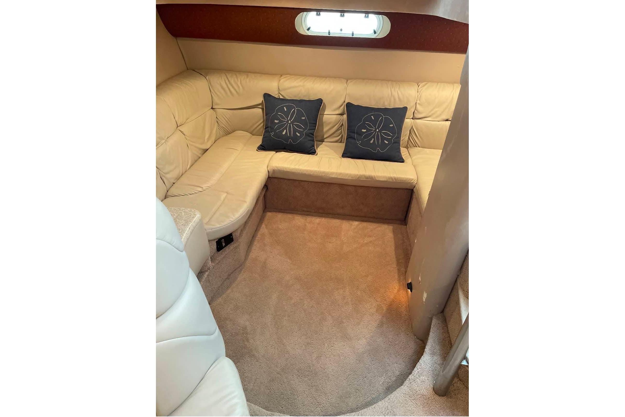 Luxurious interior of 2003 Formula 40 Performance Cruiser with beige seating and decorative pillows.