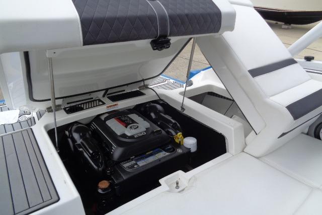 2019 Monterey 218SS Super Sport boat engine compartment with open hatch, showcasing engine details.