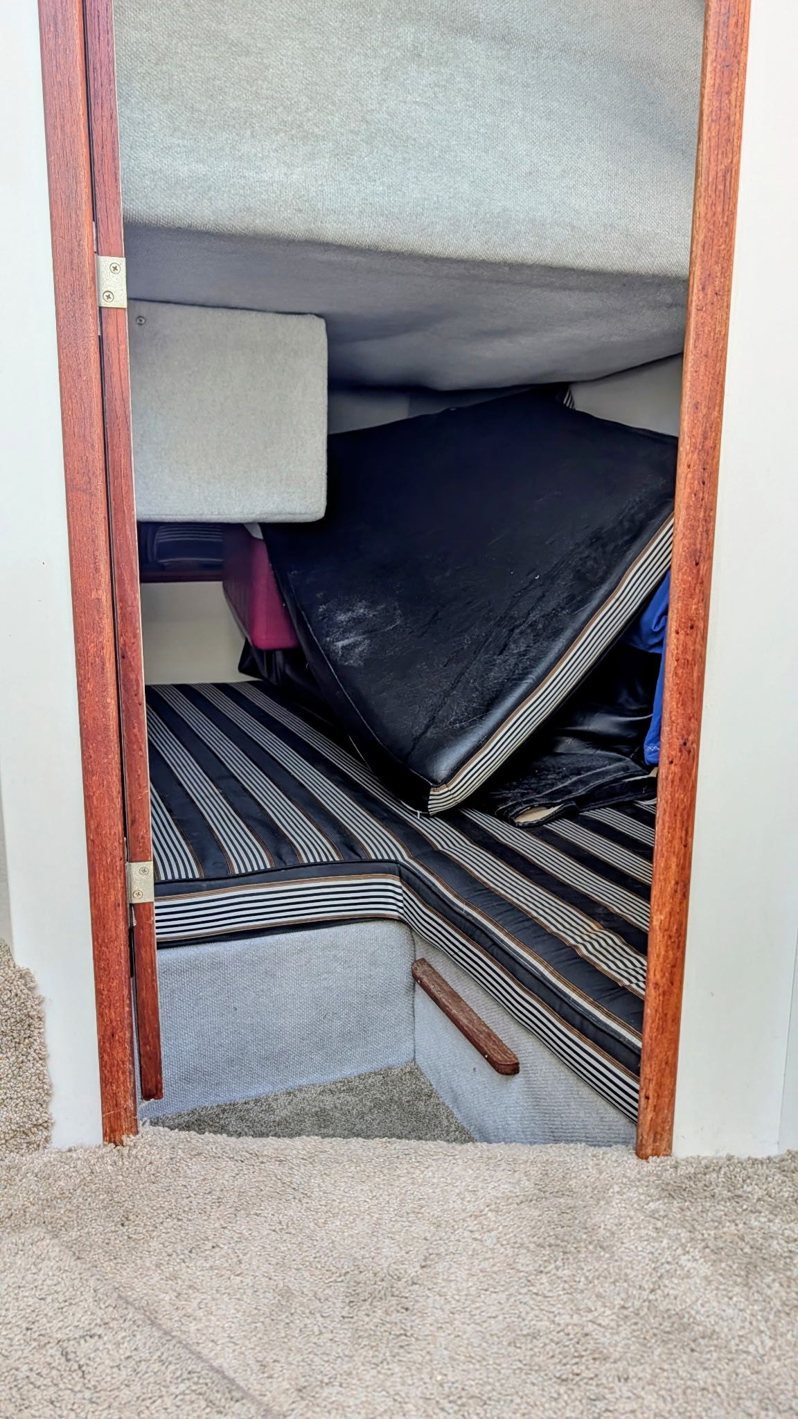 Interior of a 1987 Chris-Craft 320 Amerosport Express with striped upholstery.