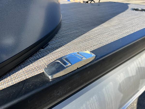 Close-up of a boat deck with a metal fitting.