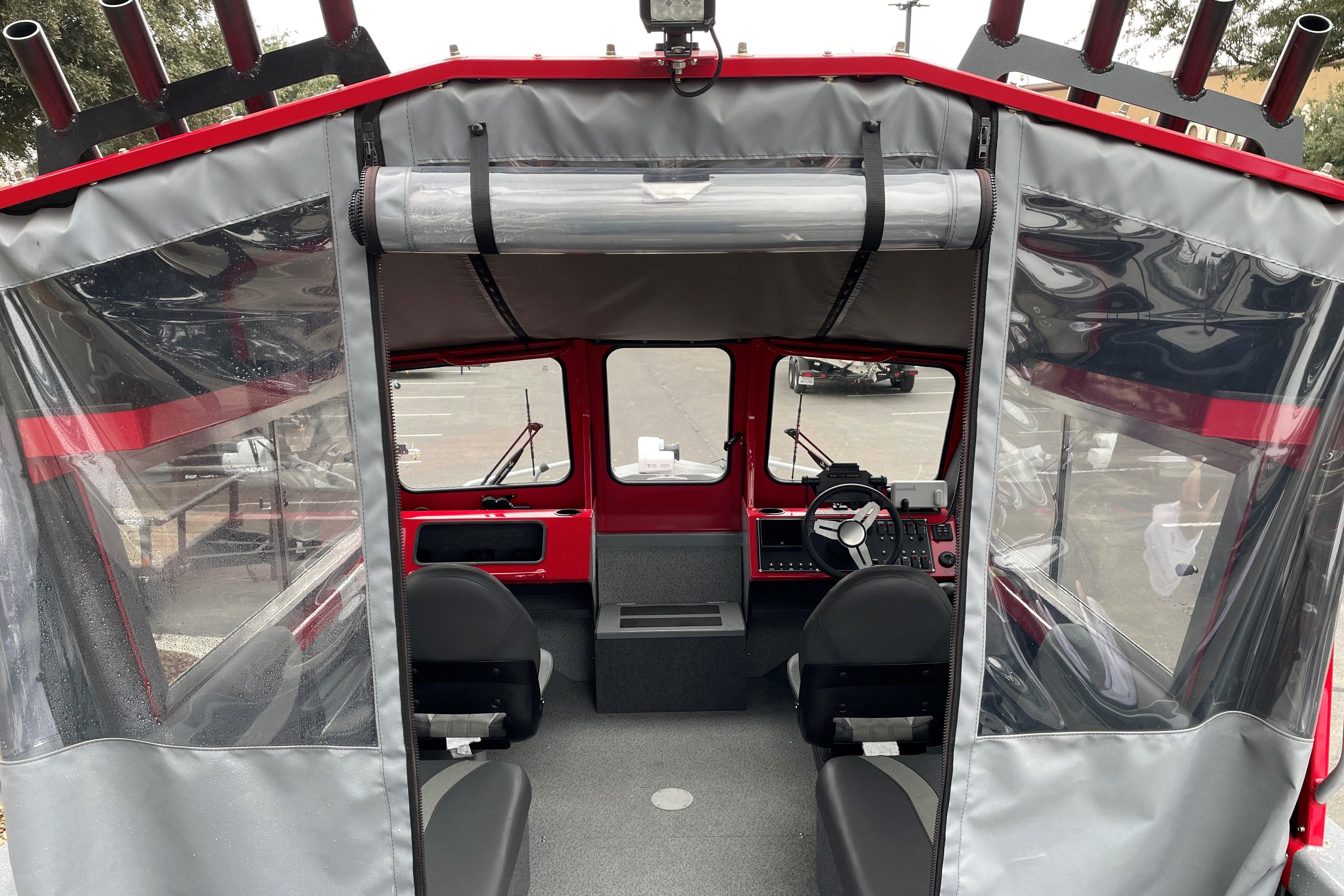 Interior view of 2024 Spartan 200 Astoria boat with steering console and seating.