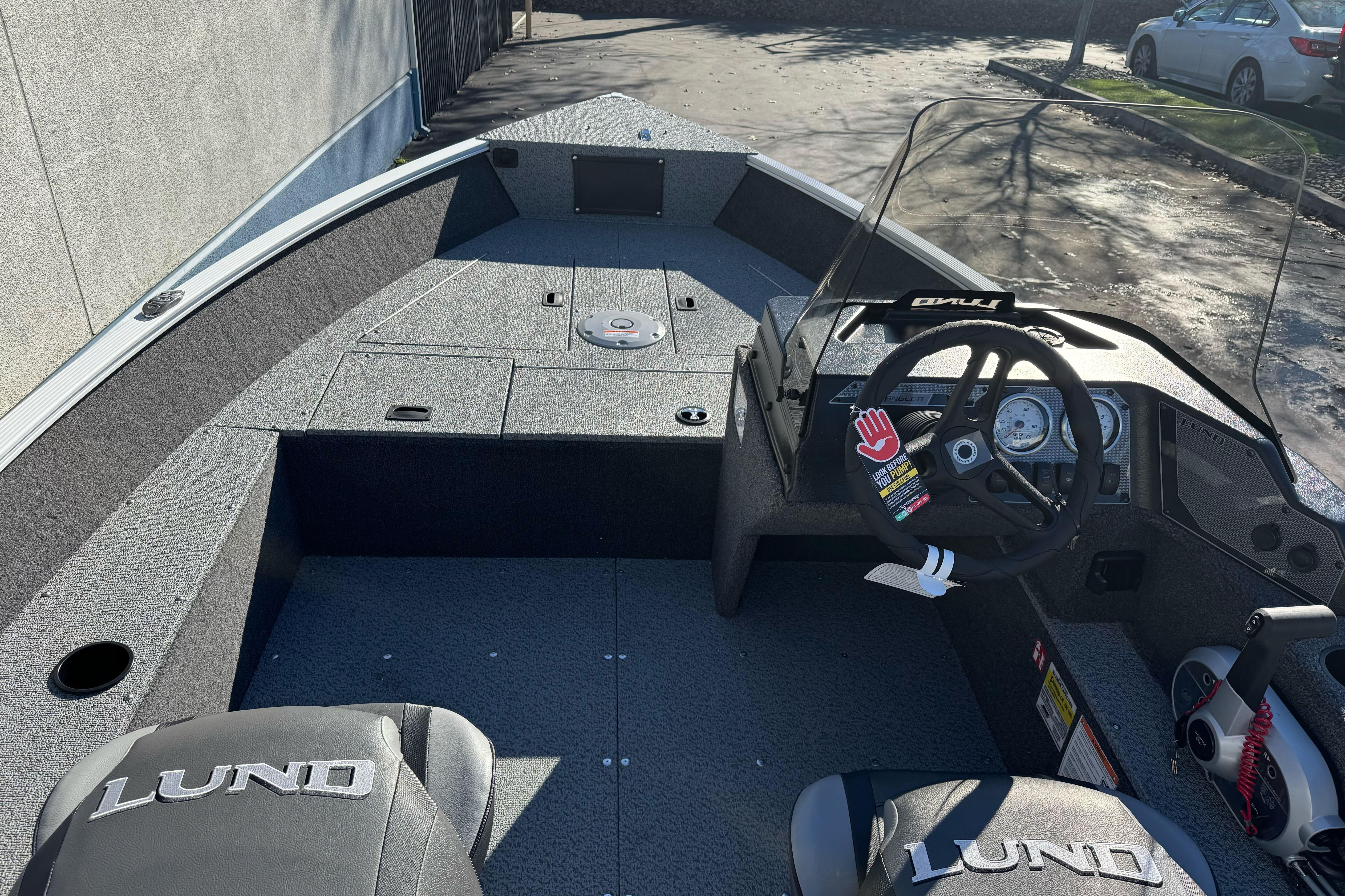 2026 Lund 1650 Angler SS boat interior with steering console and seating.