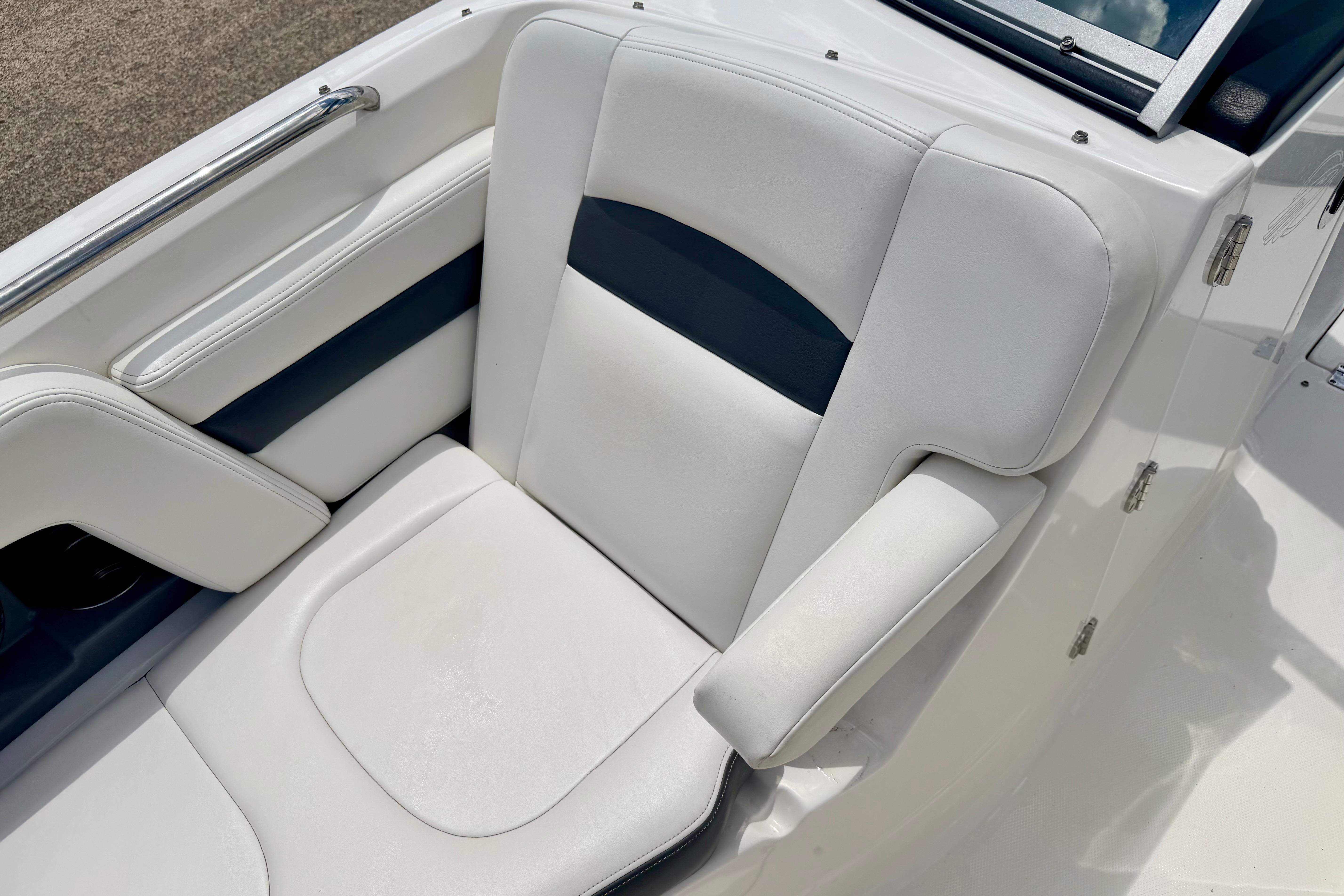 2015 Chaparral Sunesta 264 boat seat with white and navy upholstery.