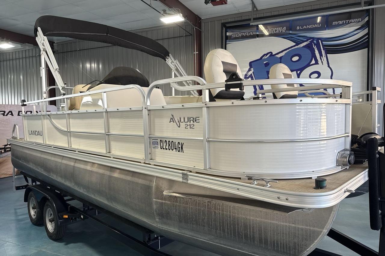 2018 Landau Alure 212 Fish pontoon boat on trailer in indoor showroom.