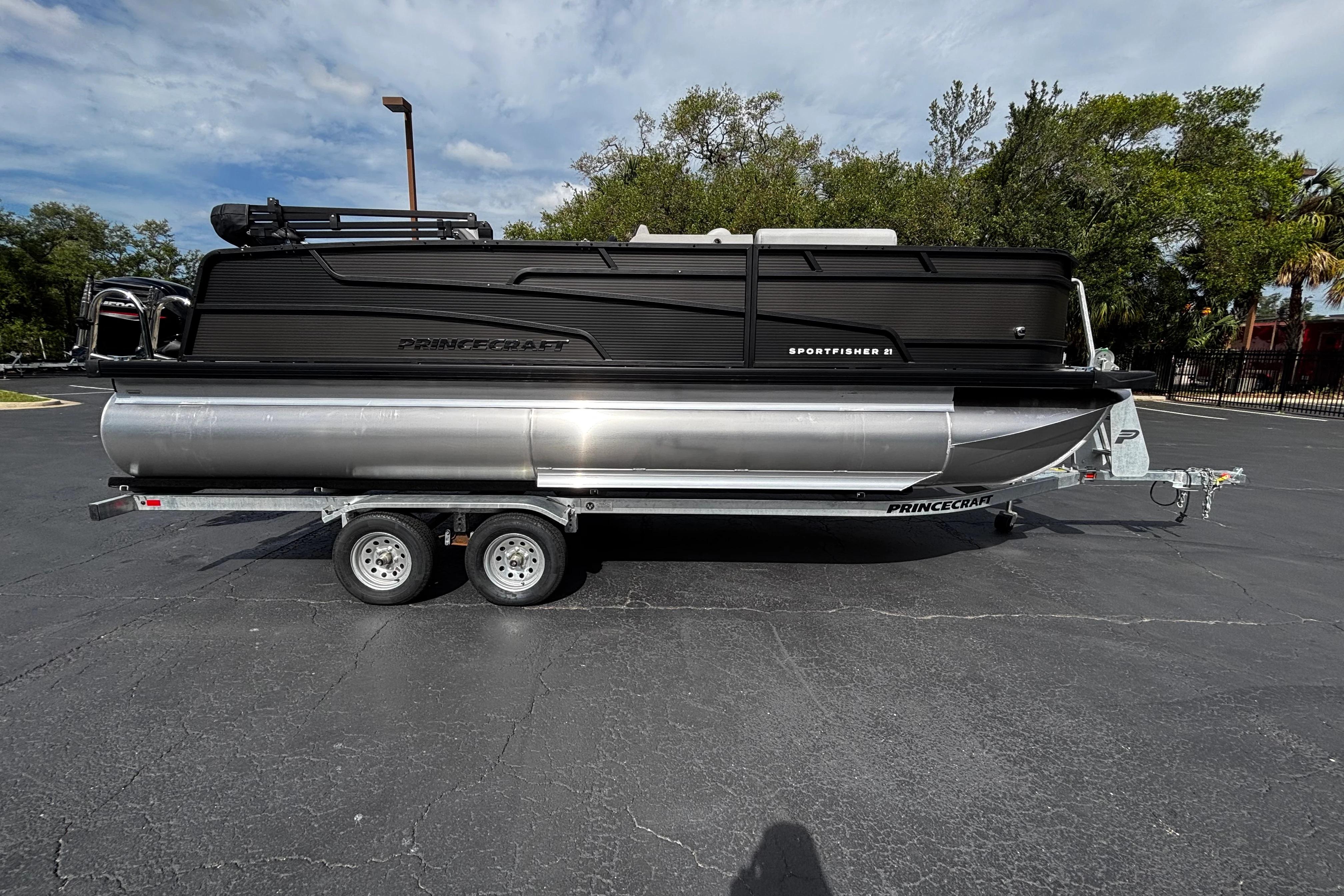 2026 Princecraft Sportfisher 21-2S pontoon boat on trailer, parked outdoors.