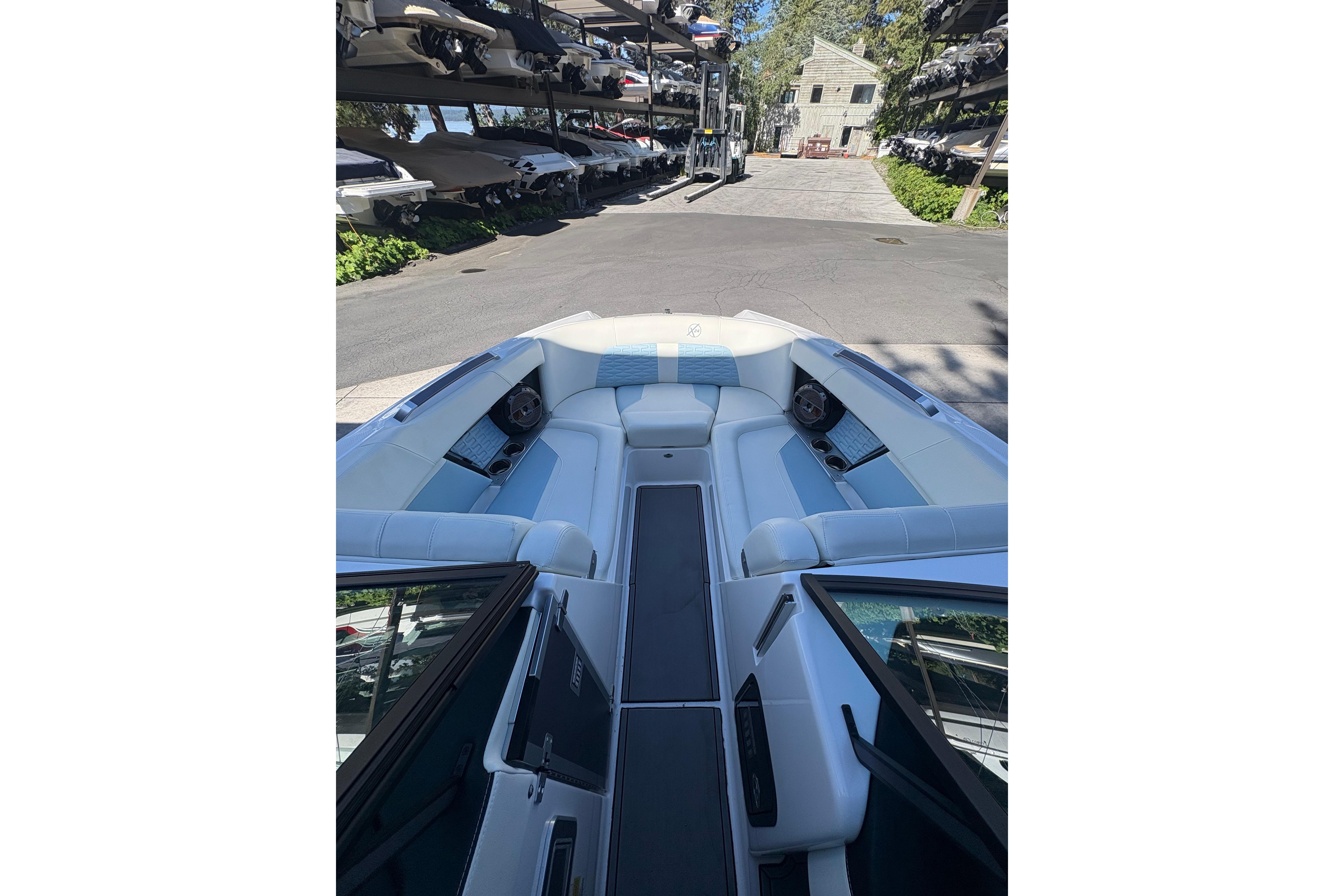 2022 MasterCraft X24 boat interior with white seating, docked in a marina.
