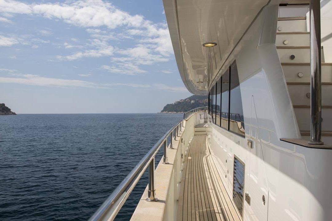Side deck view of 2014 Fifth Ocean Yachts 24m Displacement Explorer Yacht on open sea.