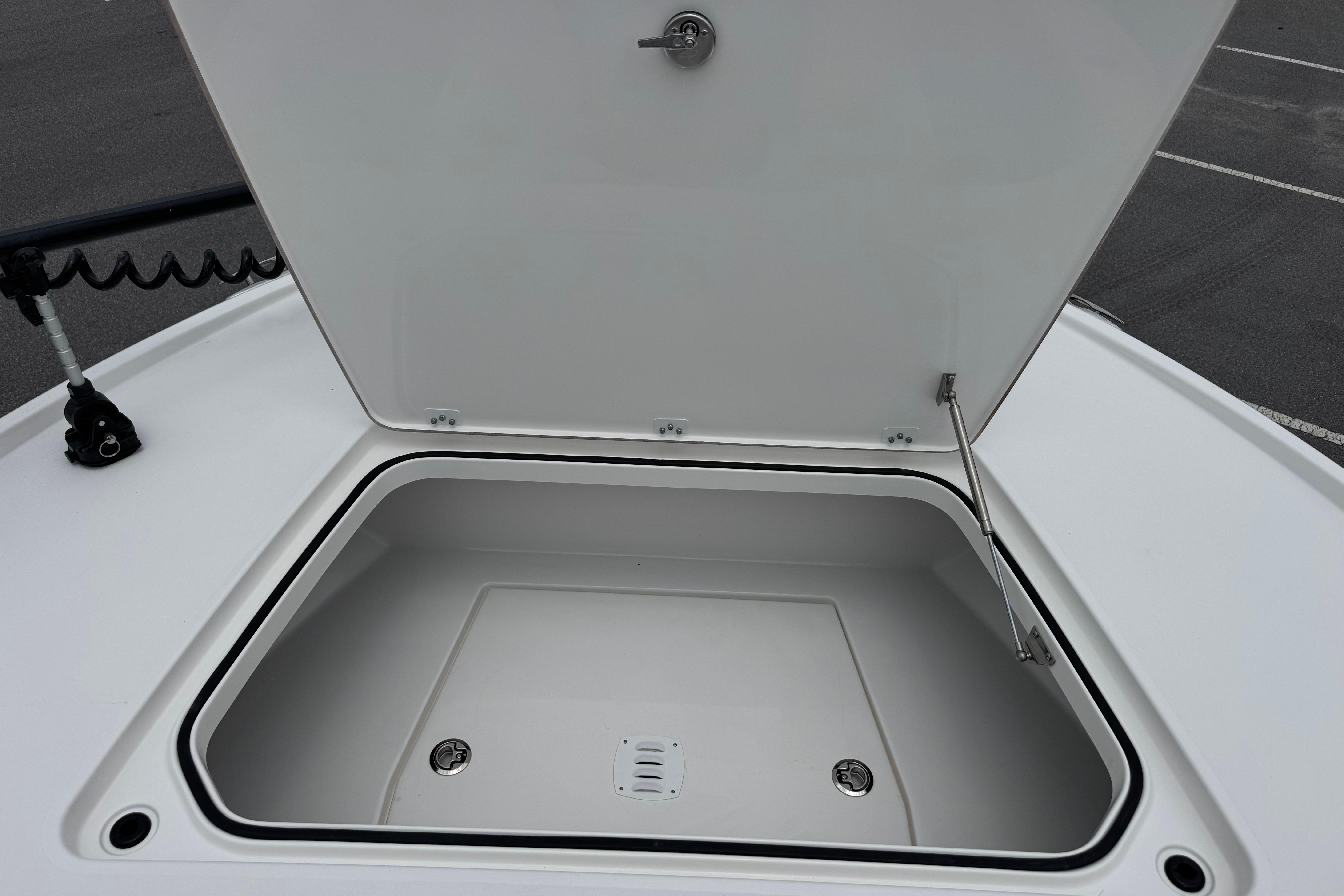 Open storage compartment on 2027 Caymas 26 HB boat, showcasing spacious interior design.
