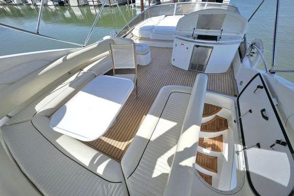 Luxurious 2005 Sunseeker Manhattan 66 yacht deck with seating and dining area.