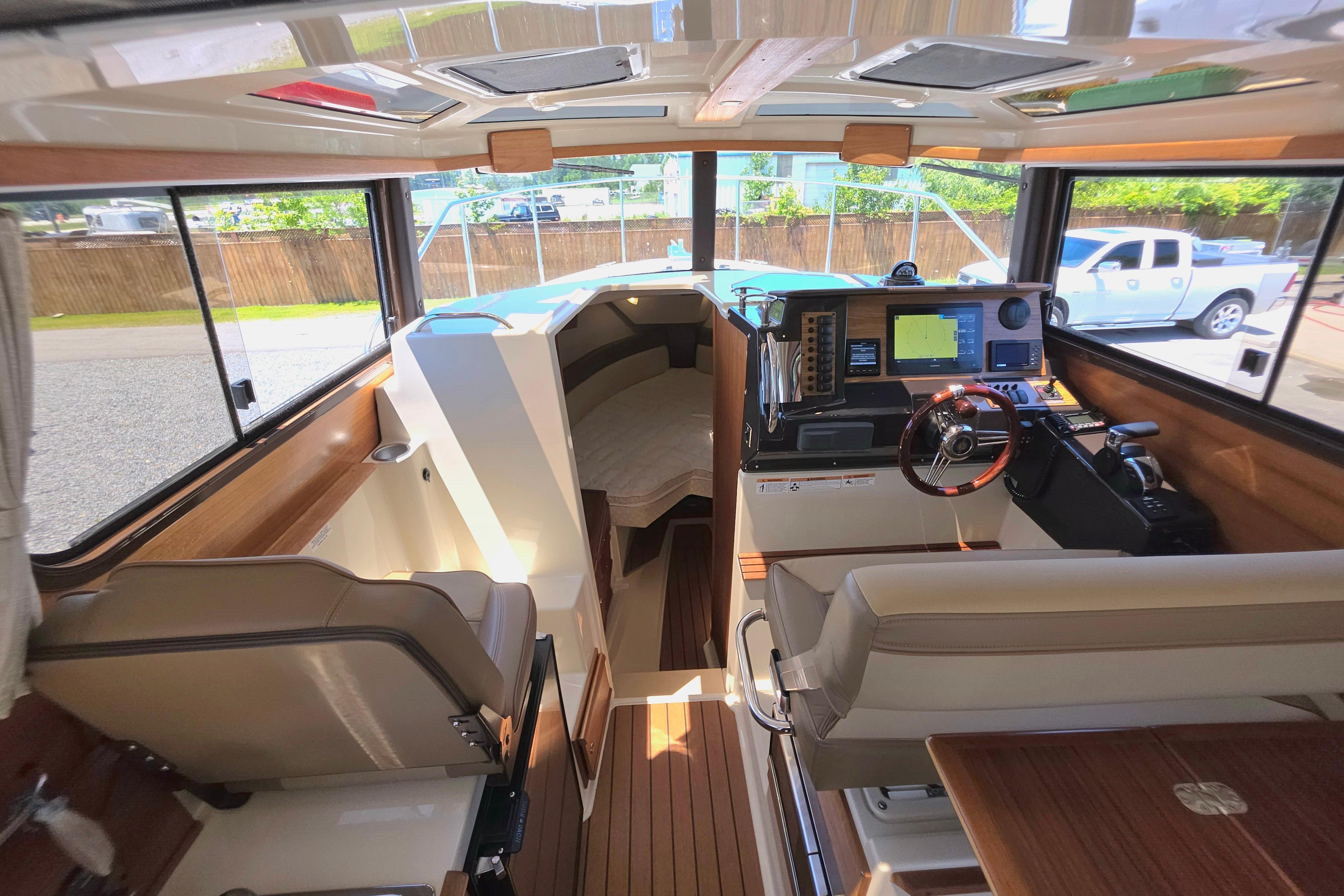 Interior of 2021 Ranger Tug R27 boat with modern navigation equipment and seating.