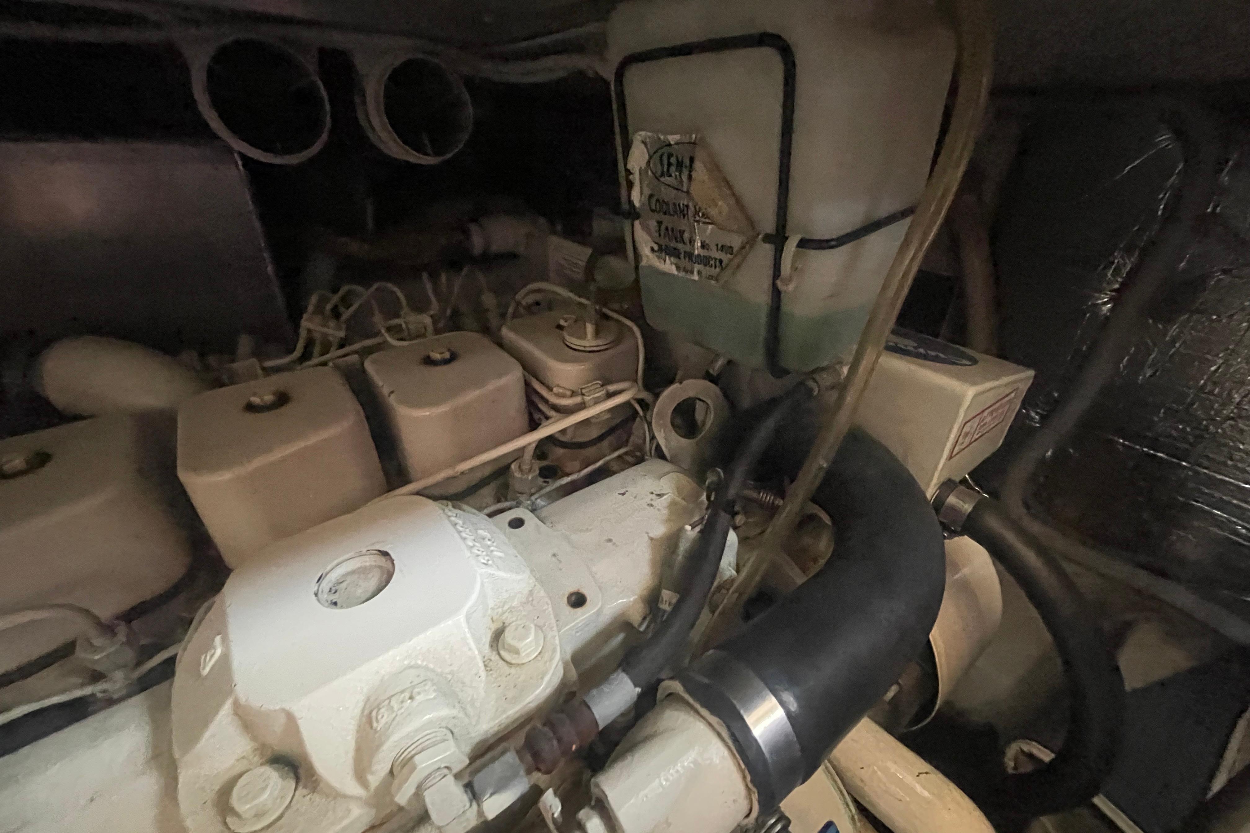 Engine compartment of a 2002 Carver 410 Sport Sedan, showing coolant tank and hoses.