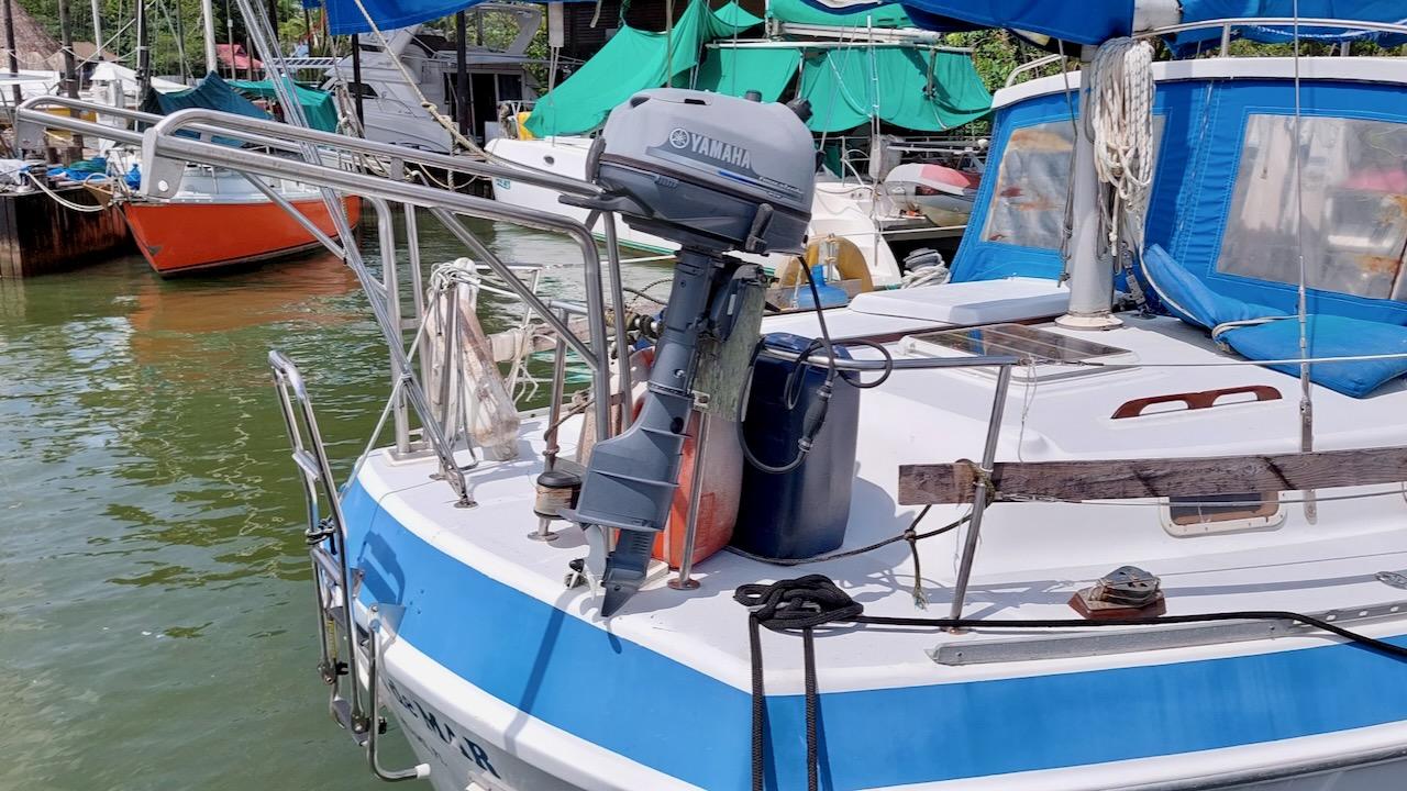1981 Morgan Out Island 41 sailboat docked, featuring a Yamaha outboard motor and blue accents.