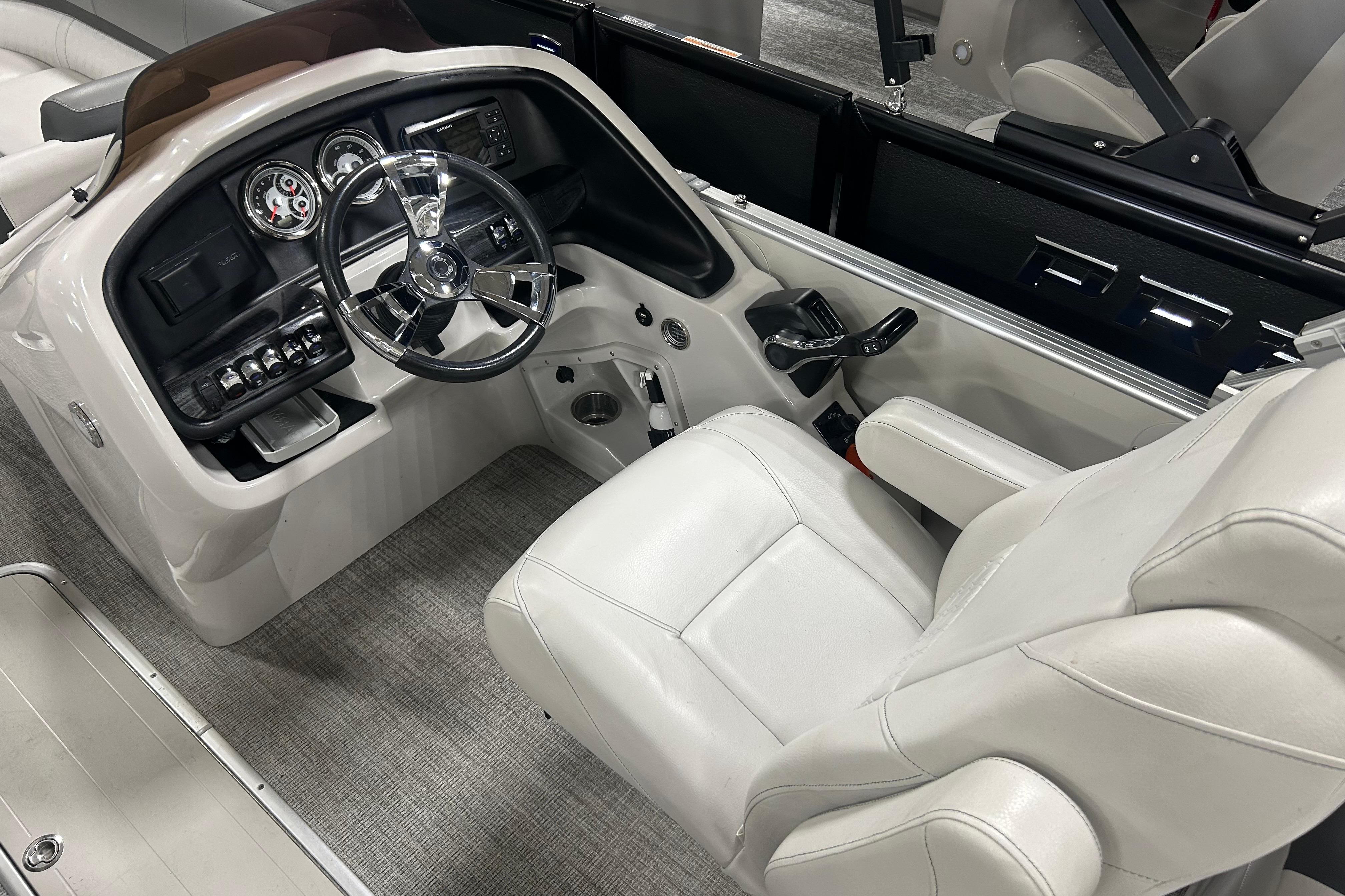 2022 Tahoe Pontoon Cascade Quad Lounger helm with steering wheel and control panel.