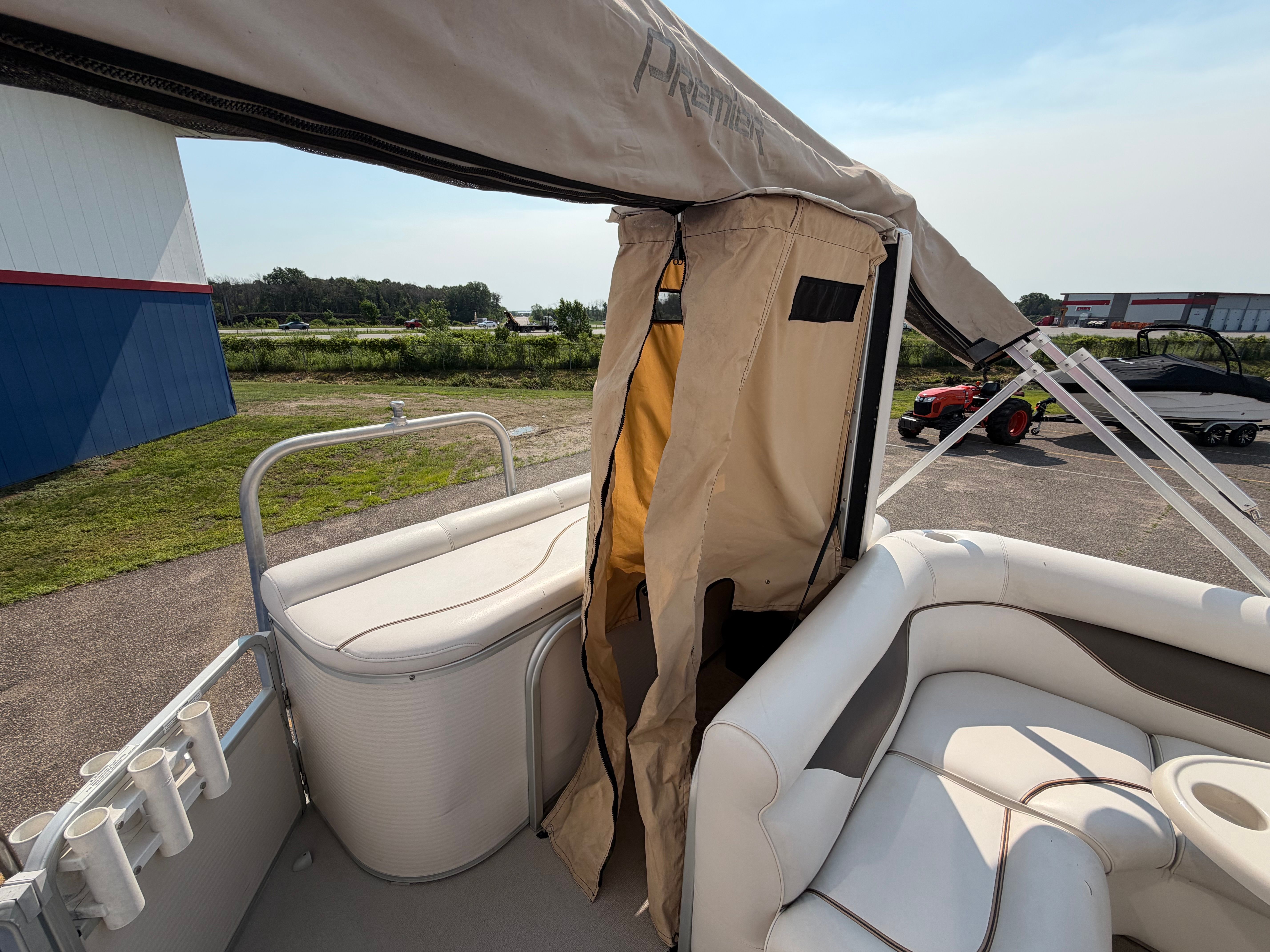 The image shows the deck of a 2007 Premier 225 Sunsation pontoon boat with seating and a sunshade.