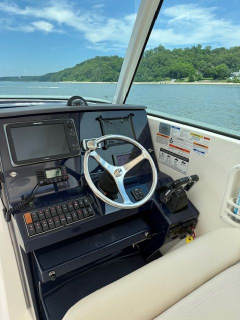 Helm of a 2015 Pursuit DC 325 Dual Console with a view of the water.