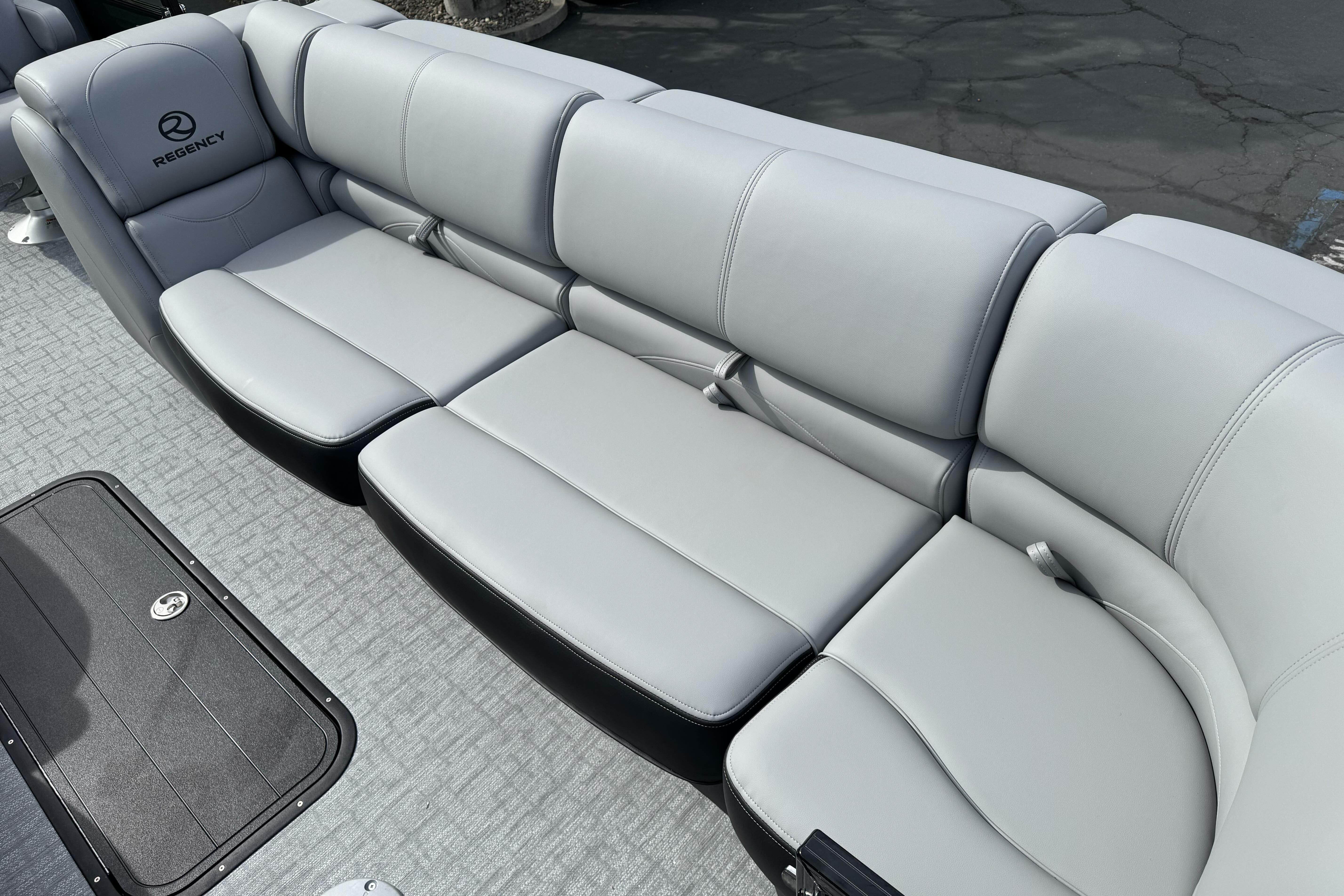 Luxurious seating on 2026 Regency 250 DL boat, featuring sleek gray upholstery.