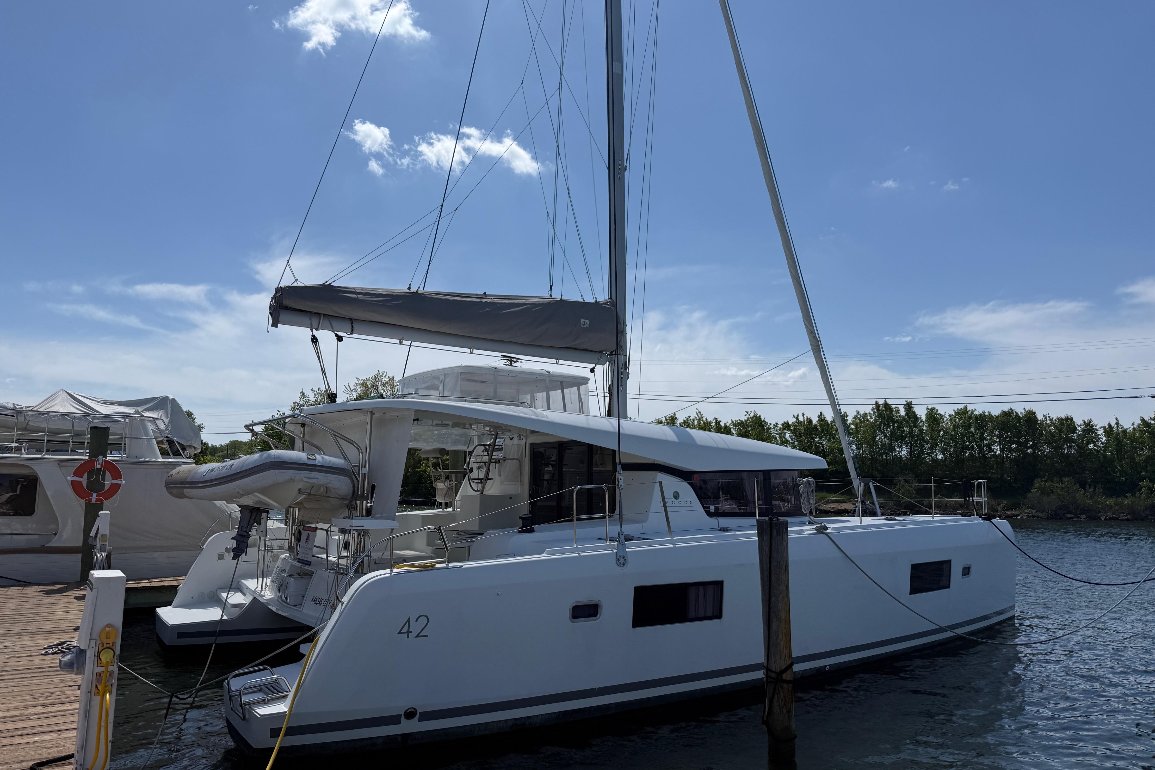 2017 Lagoon 42 catamaran docked under a clear blue sky.
