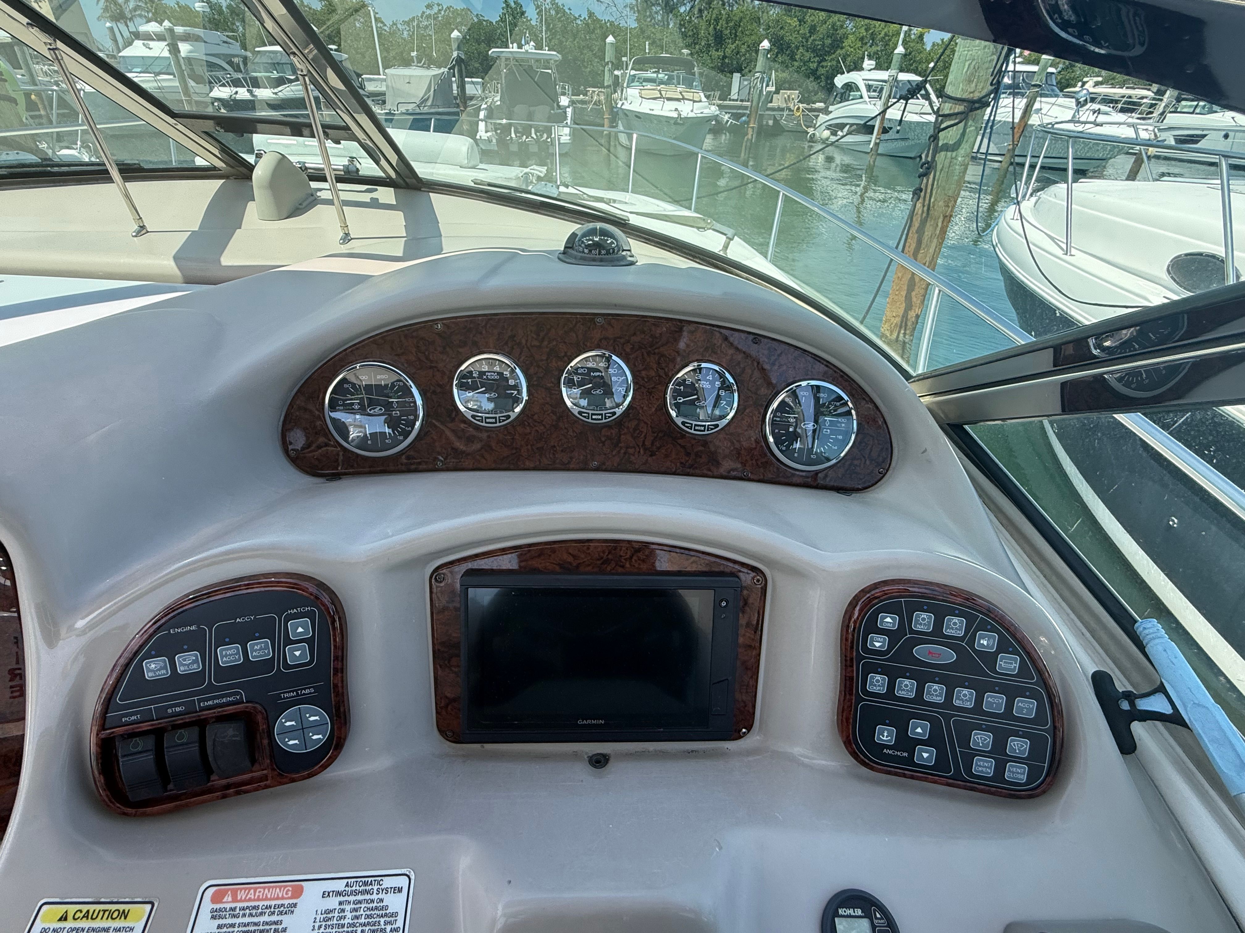 The image shows the dashboard of a 2006 Sea Ray Sundancer 320 at a marina.