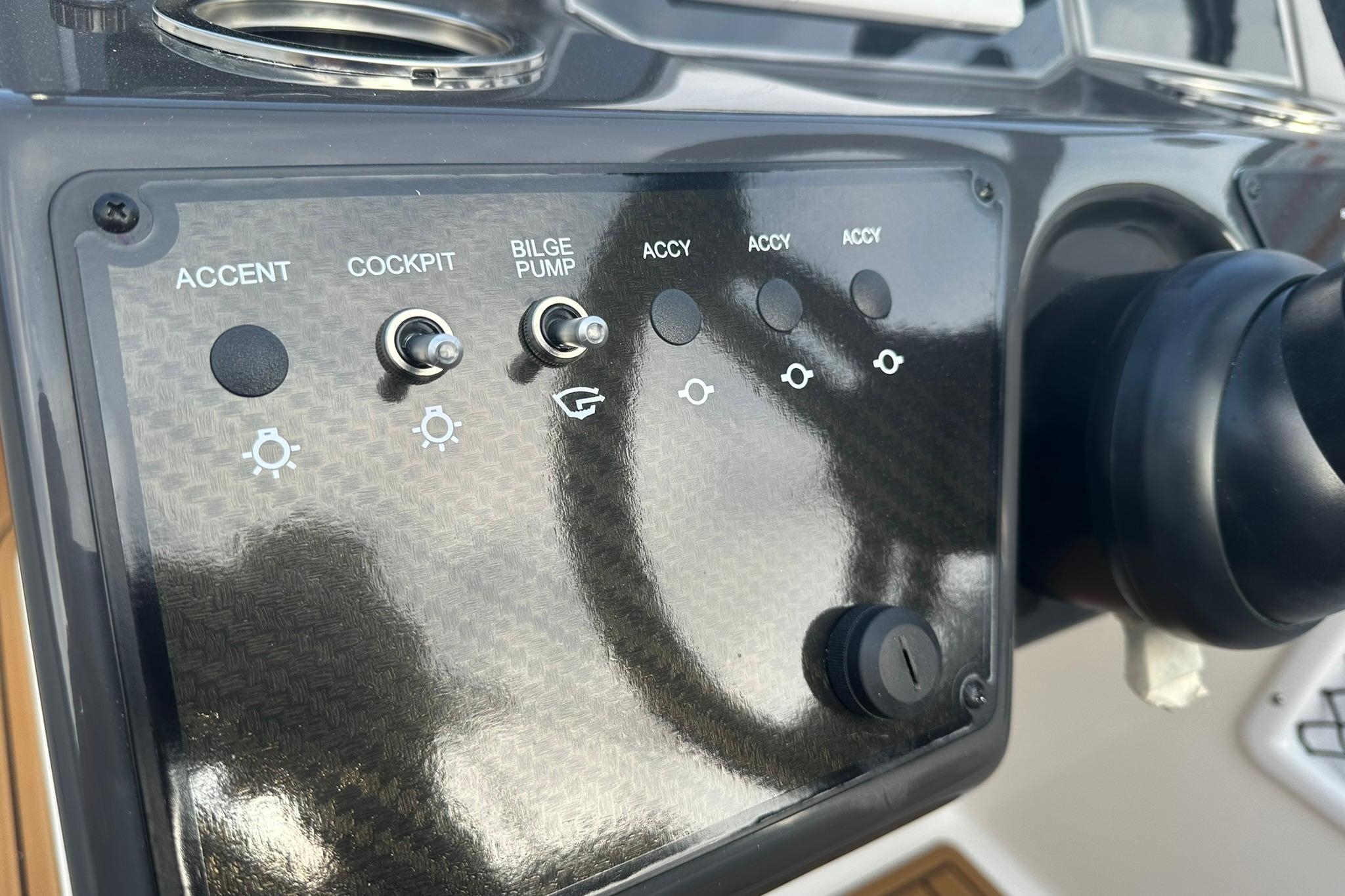 Control panel of 2026 Bayliner VR6 Bowrider OB with switches for accent, cockpit, and bilge pump.