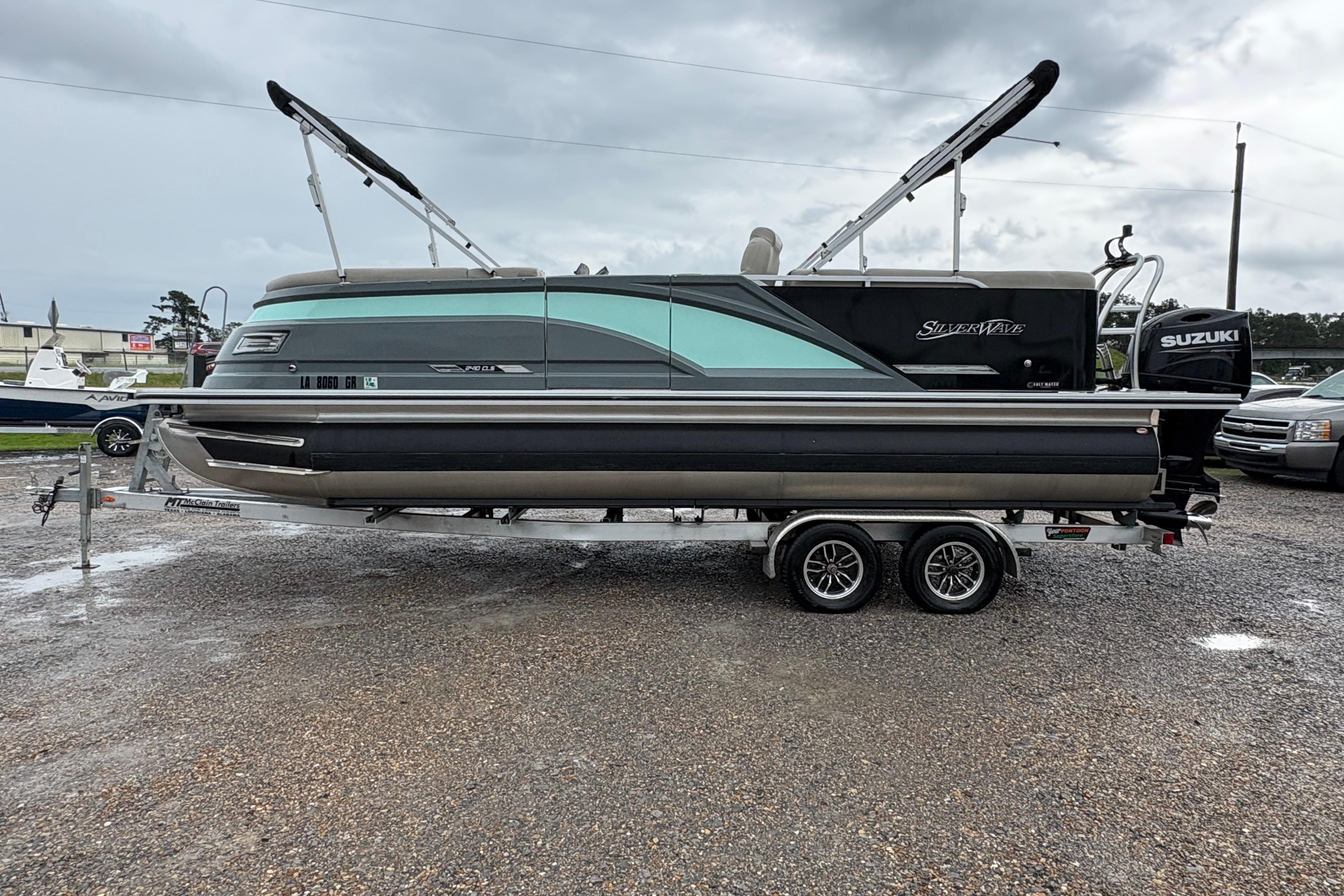 2023 SilverWave 2410 CLS pontoon boat on trailer, featuring Suzuki outboard motor.