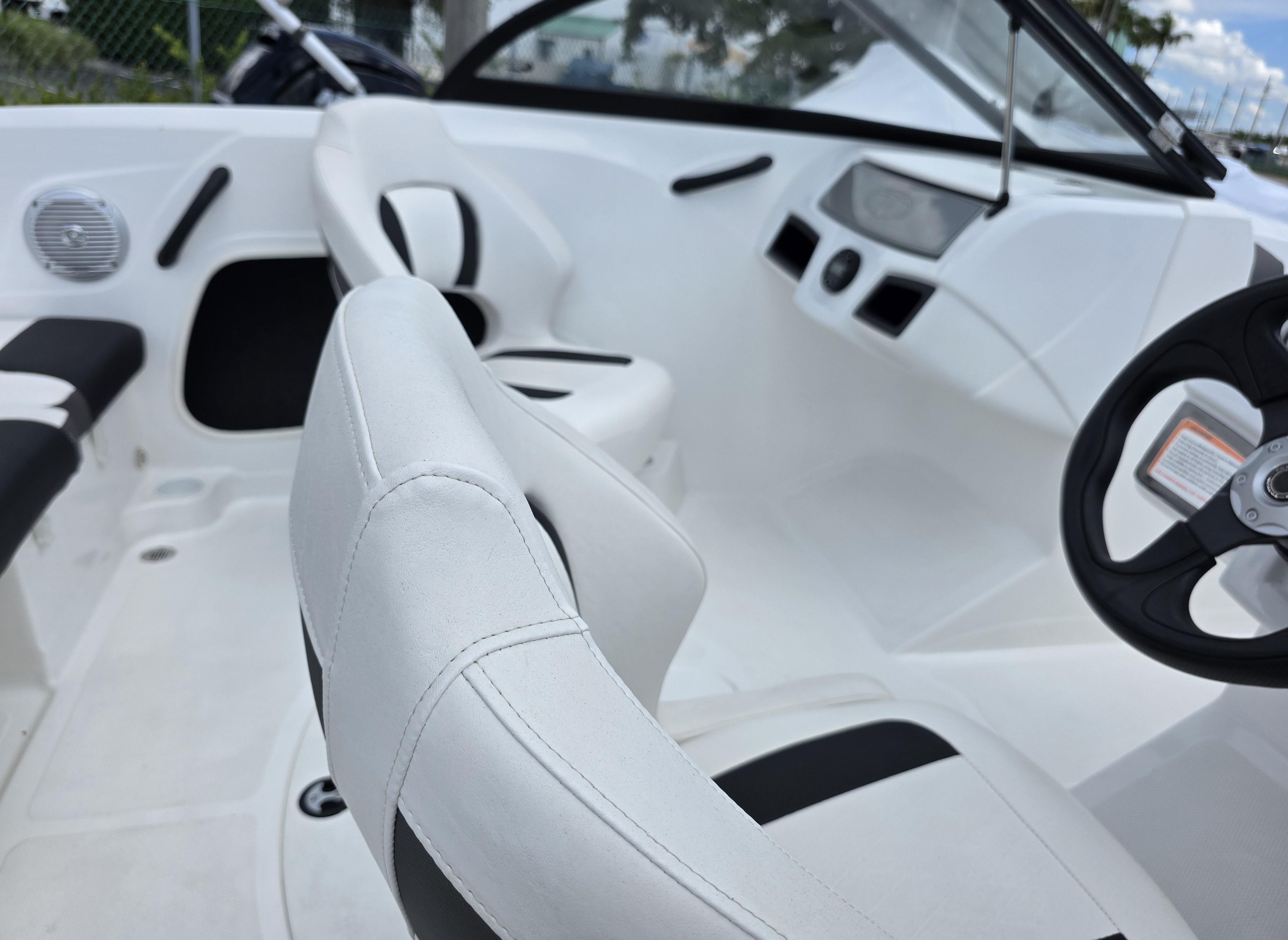 2024 Tahoe 185 S boat interior with white seating and steering wheel.