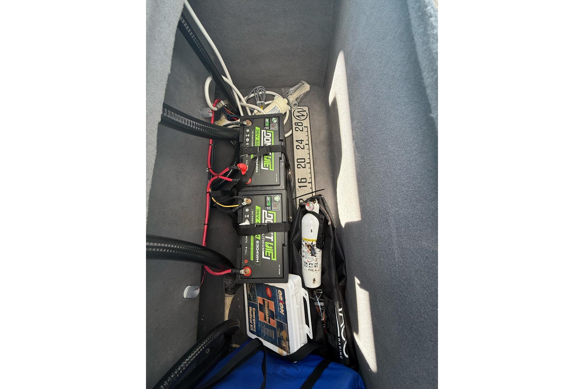Interior view of 2021 Custom Infusion 34 CC showing battery compartment and equipment storage.