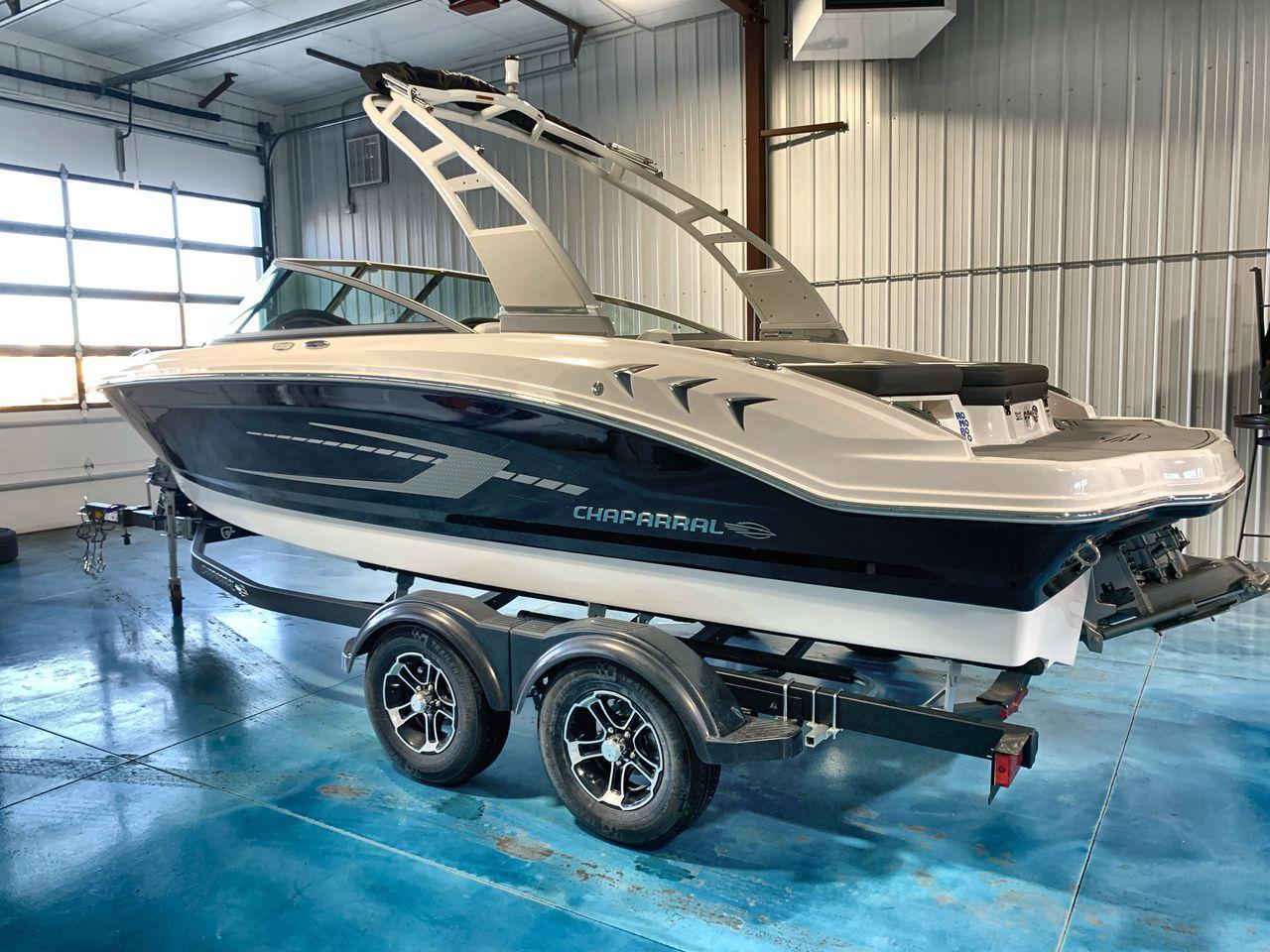 2025 Chaparral 21 SSi boat on trailer in indoor showroom.