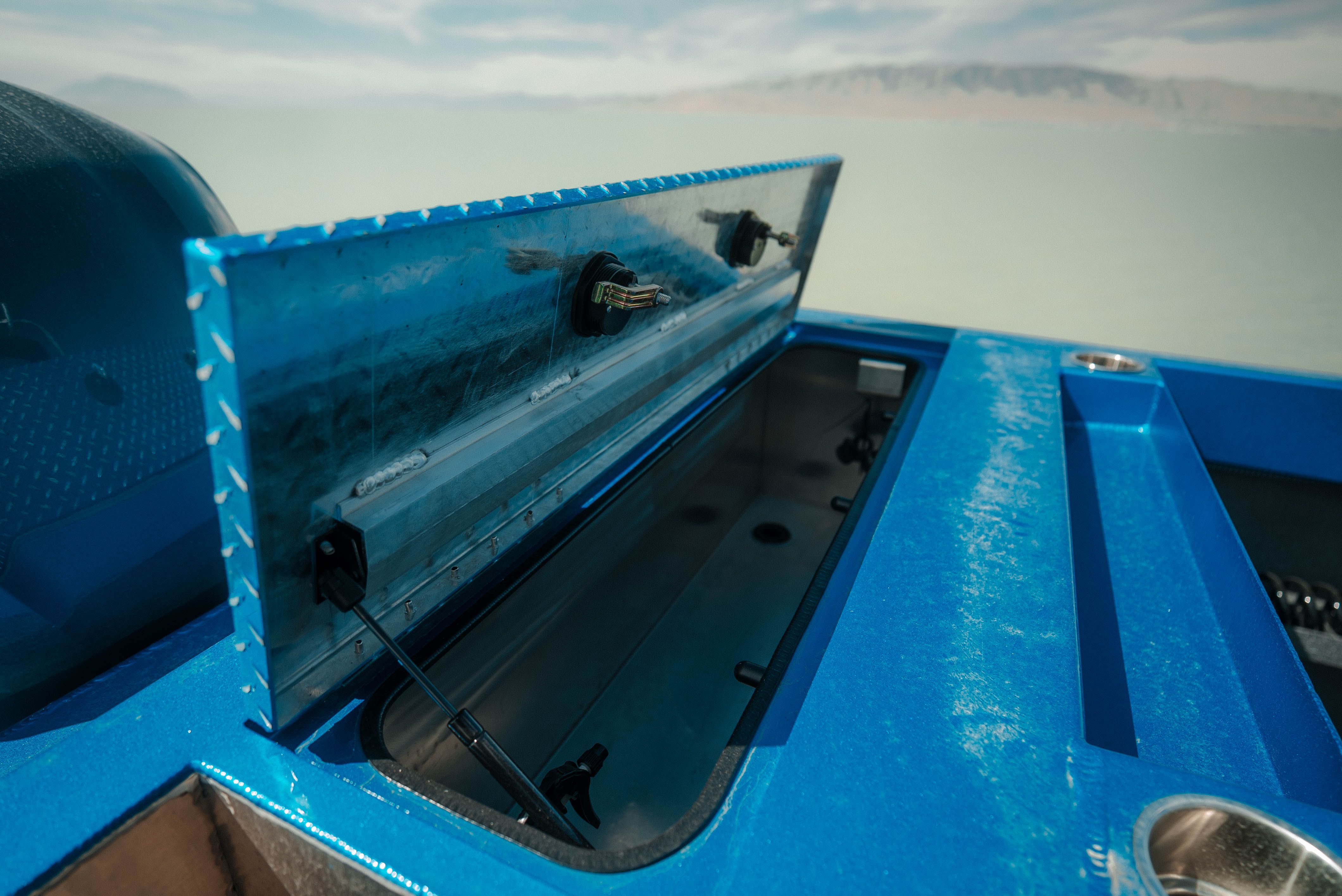 2025 Excel Buoy 10 boat with open storage compartment.