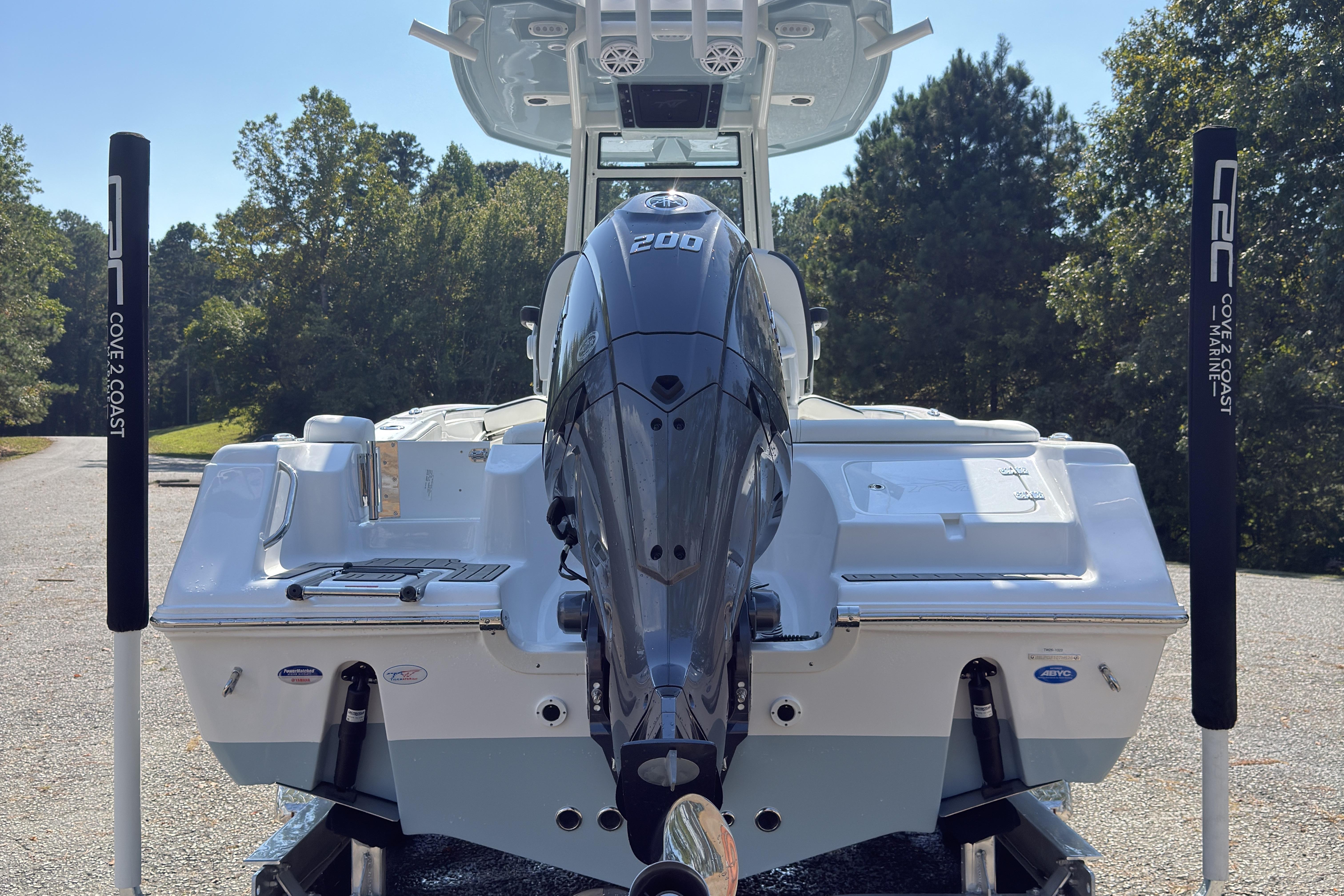 2026 Tidewater 220 LXF boat with powerful 200 engine, parked outdoors.