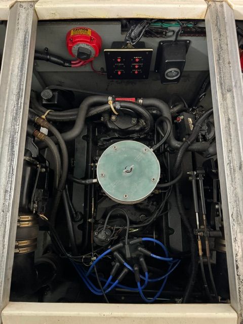 Engine compartment of a 1992 Sea Ray 290 Sundancer with visible hoses and wires.