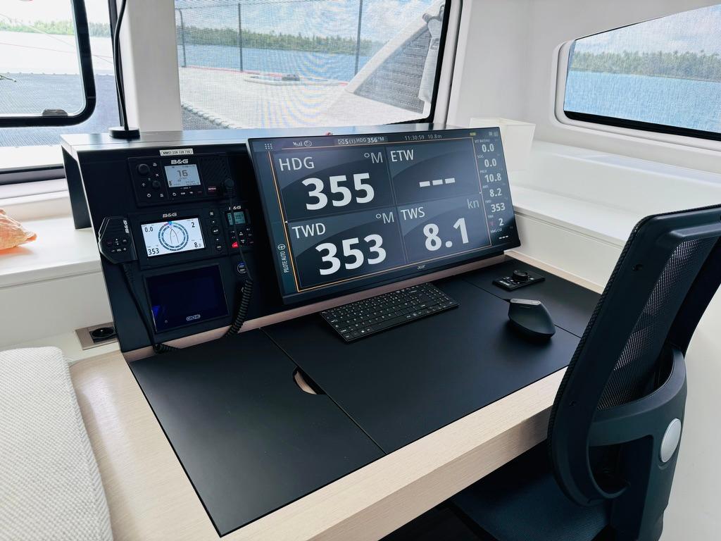 Modern navigation station on 2022 Outremer 5X catamaran with digital displays and controls.