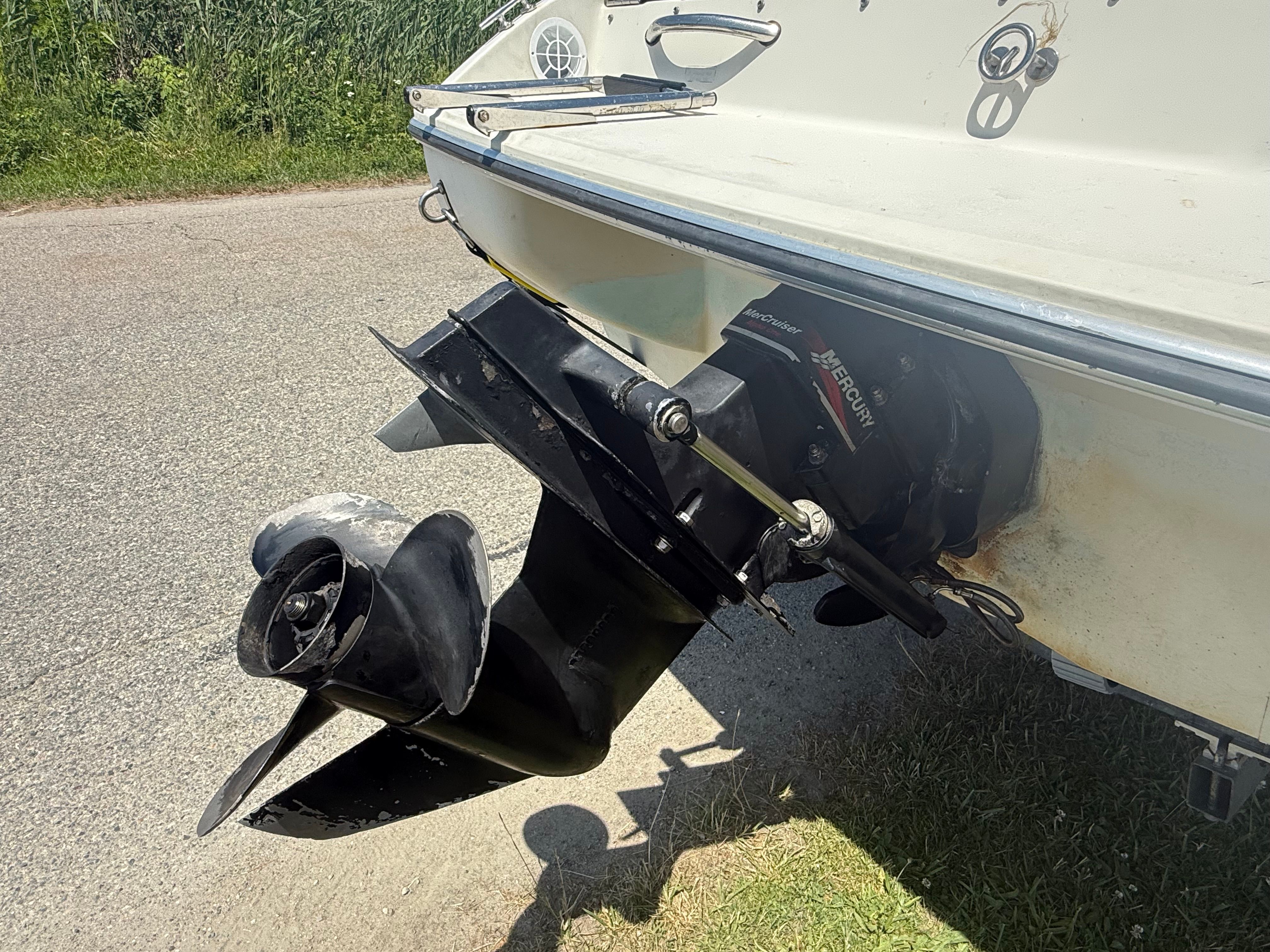 The image shows a boat's drive unit on dry land.
