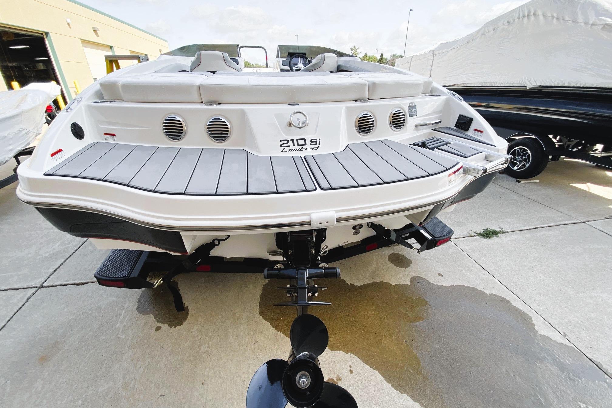 2023 Tahoe 210 Si Limited boat, rear view, on a concrete surface.