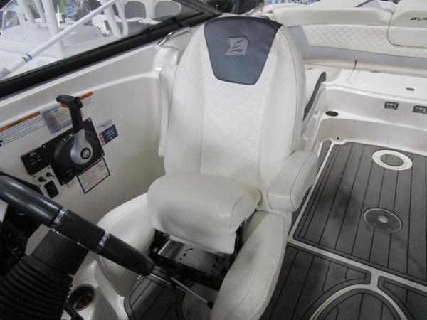 2017 Larson 292 LXI boat interior with white captain's chair and steering wheel.