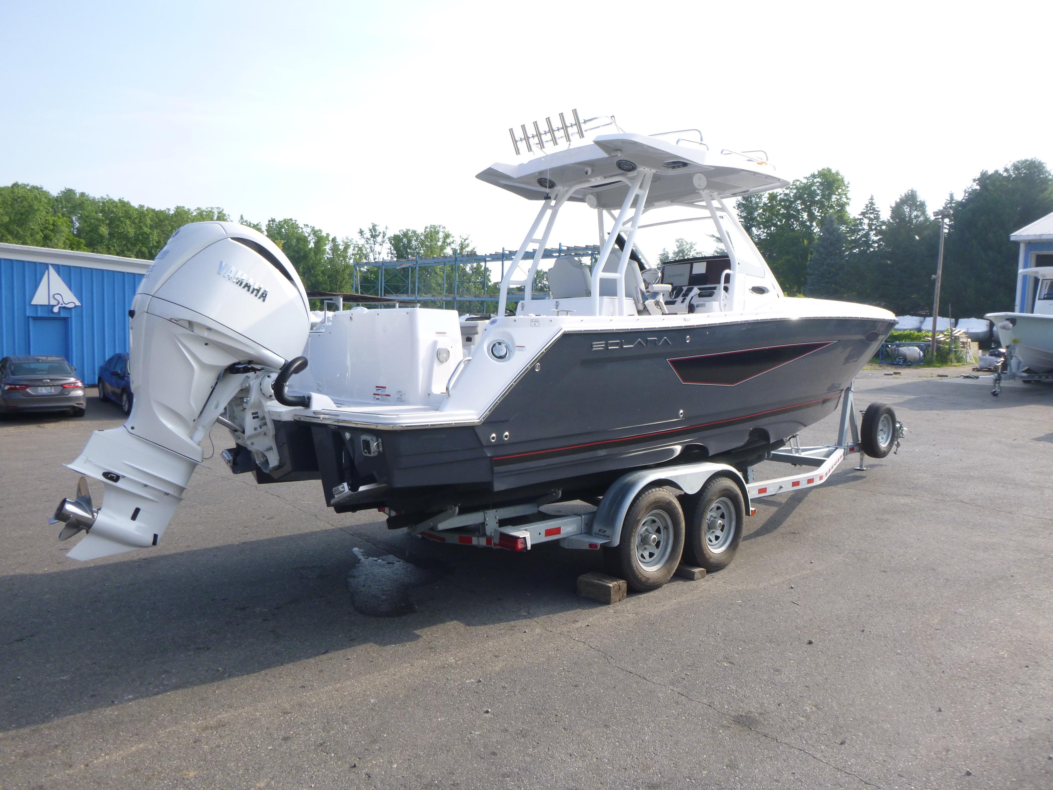 2025 Solara S-250 CW boat on trailer with Yamaha outboard motor in parking lot.