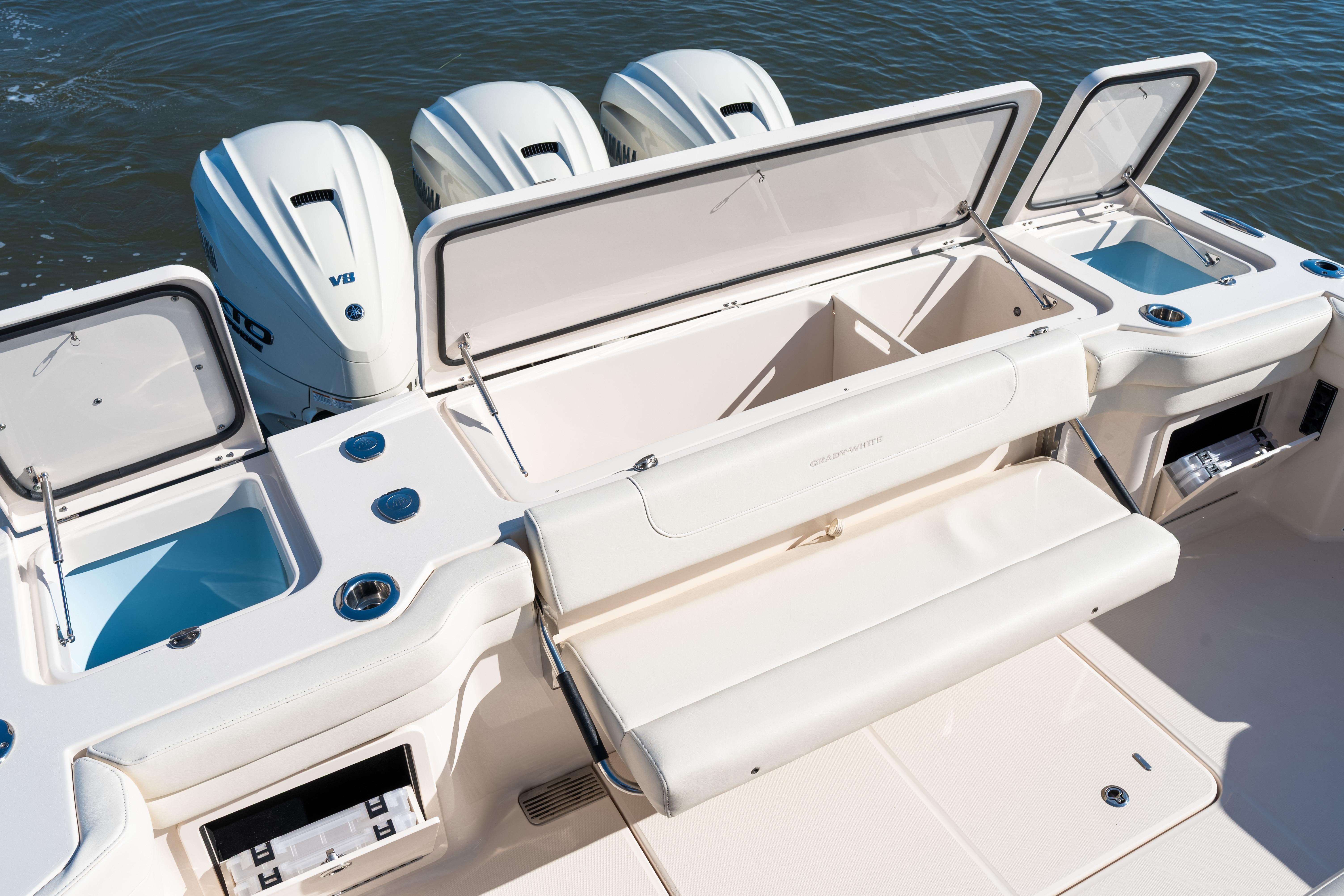 2025 Grady-White Canyon 386 boat with open storage compartments and triple outboard engines.