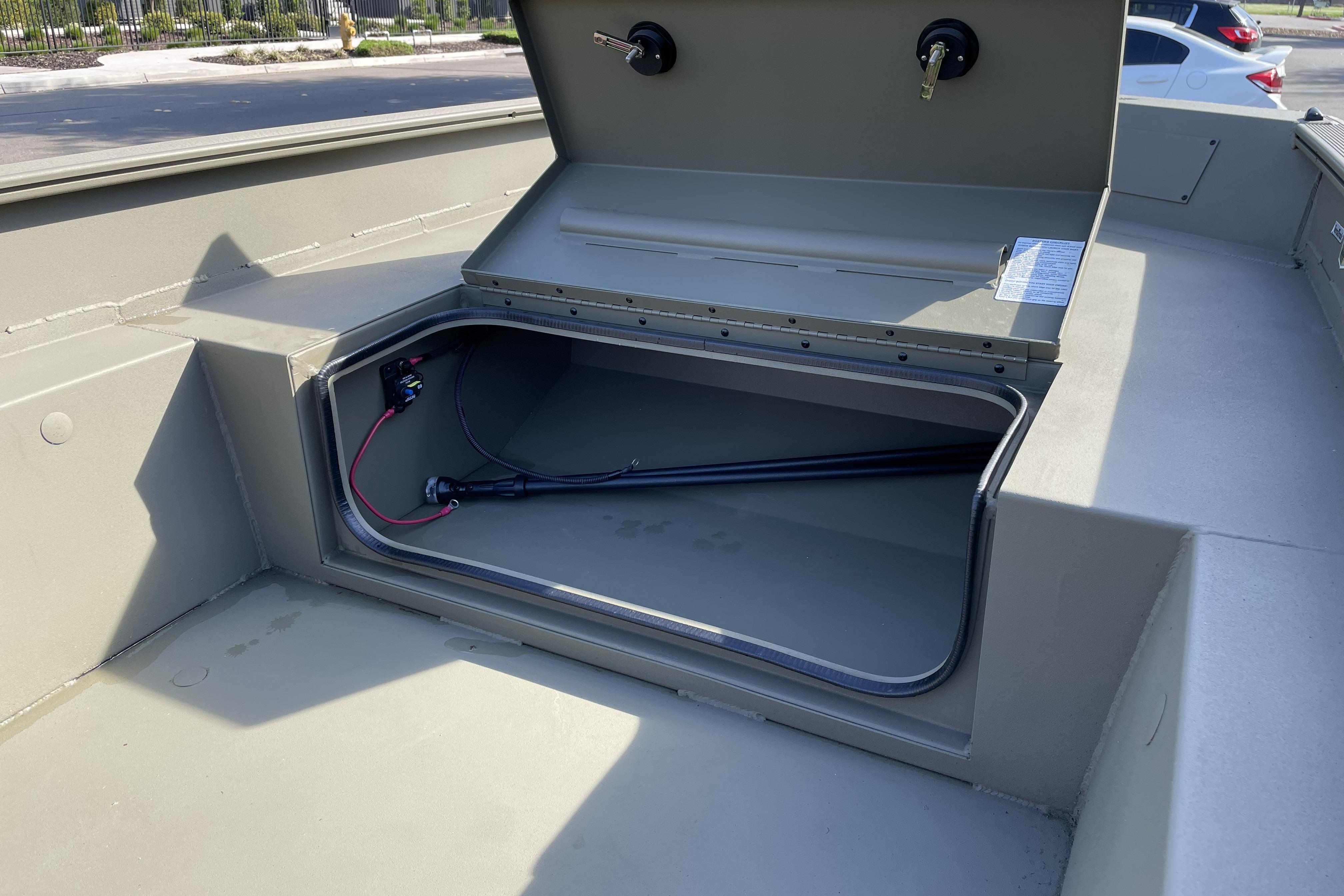 Open storage compartment in 2026 Tracker Grizzly 1650 T Prairie Wings Edition boat.