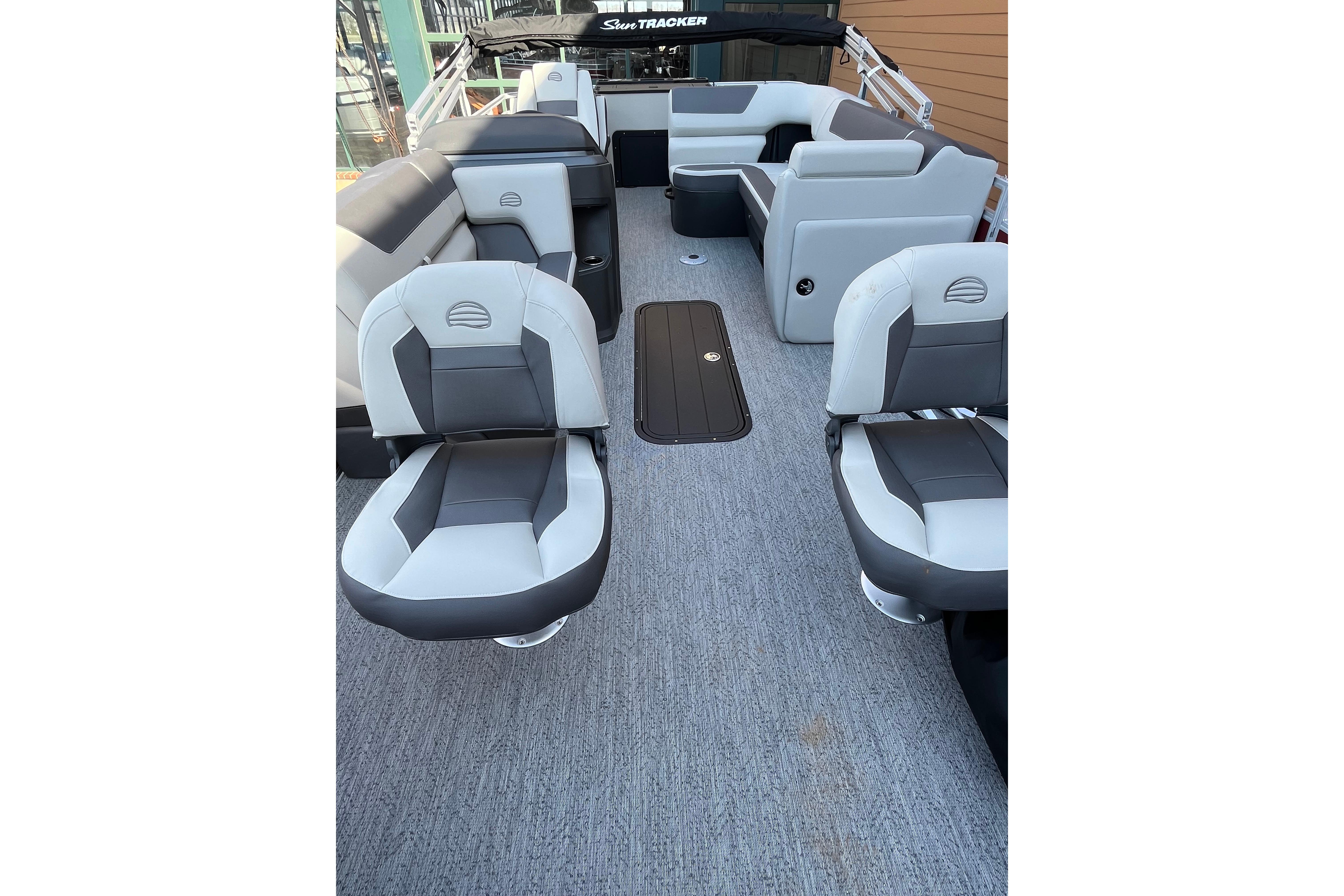 2026 Sun Tracker Fishin' Barge 22 XP3 interior with gray and white seating.