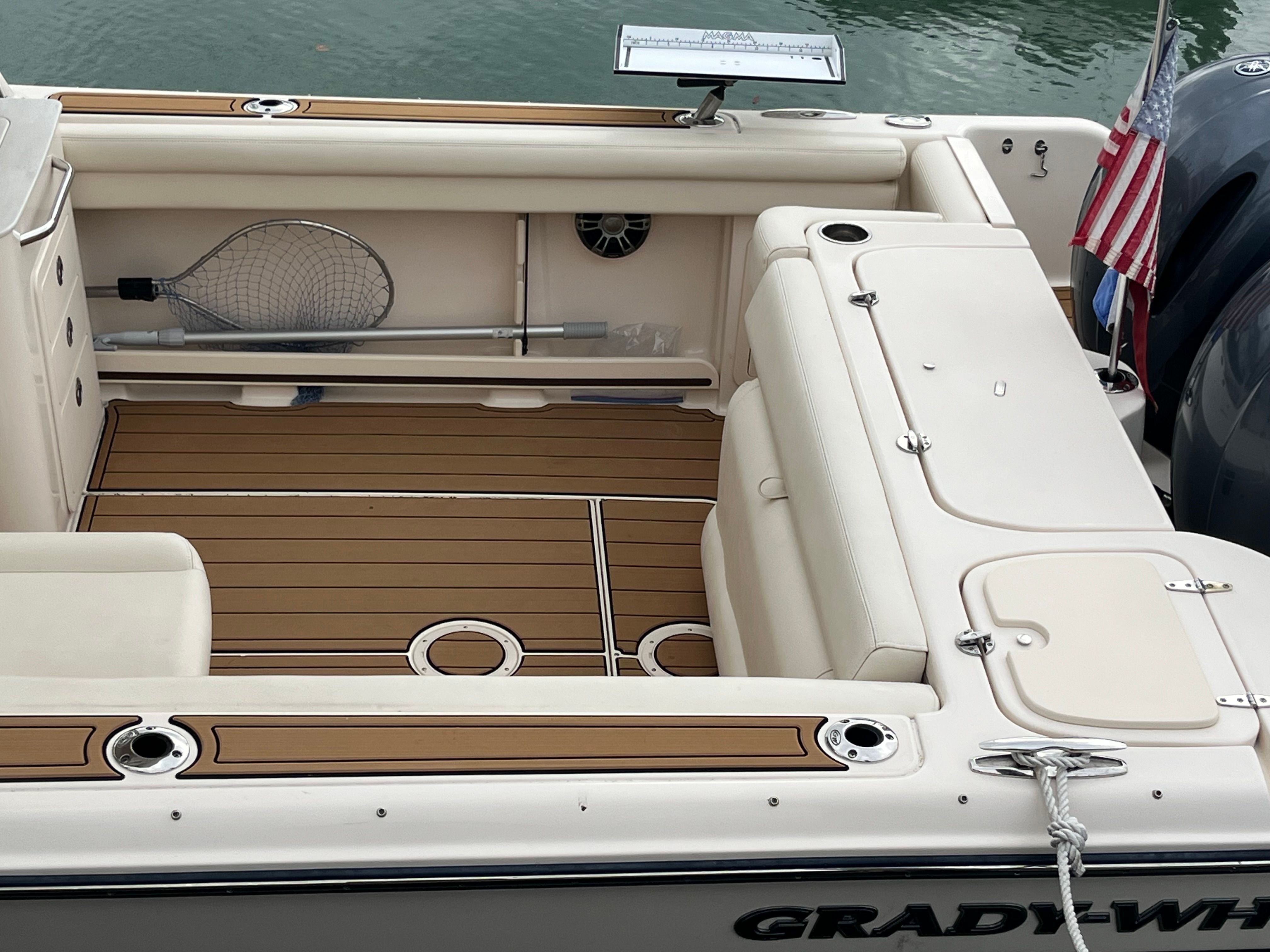 2022 Grady-White Freedom 275 boat with teak flooring and fishing gear.