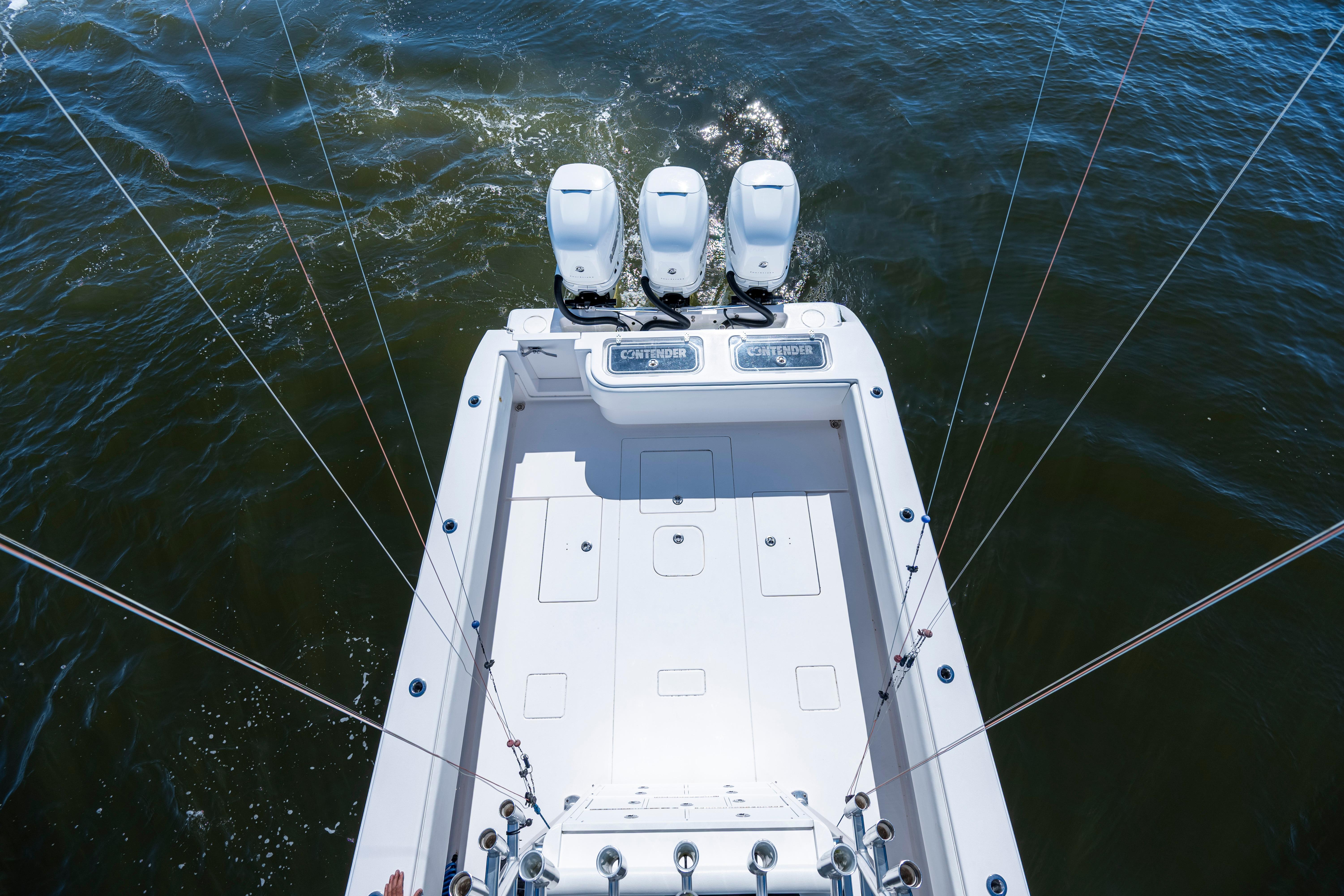 2015 Contender 39 ST boat with triple engines on open water.