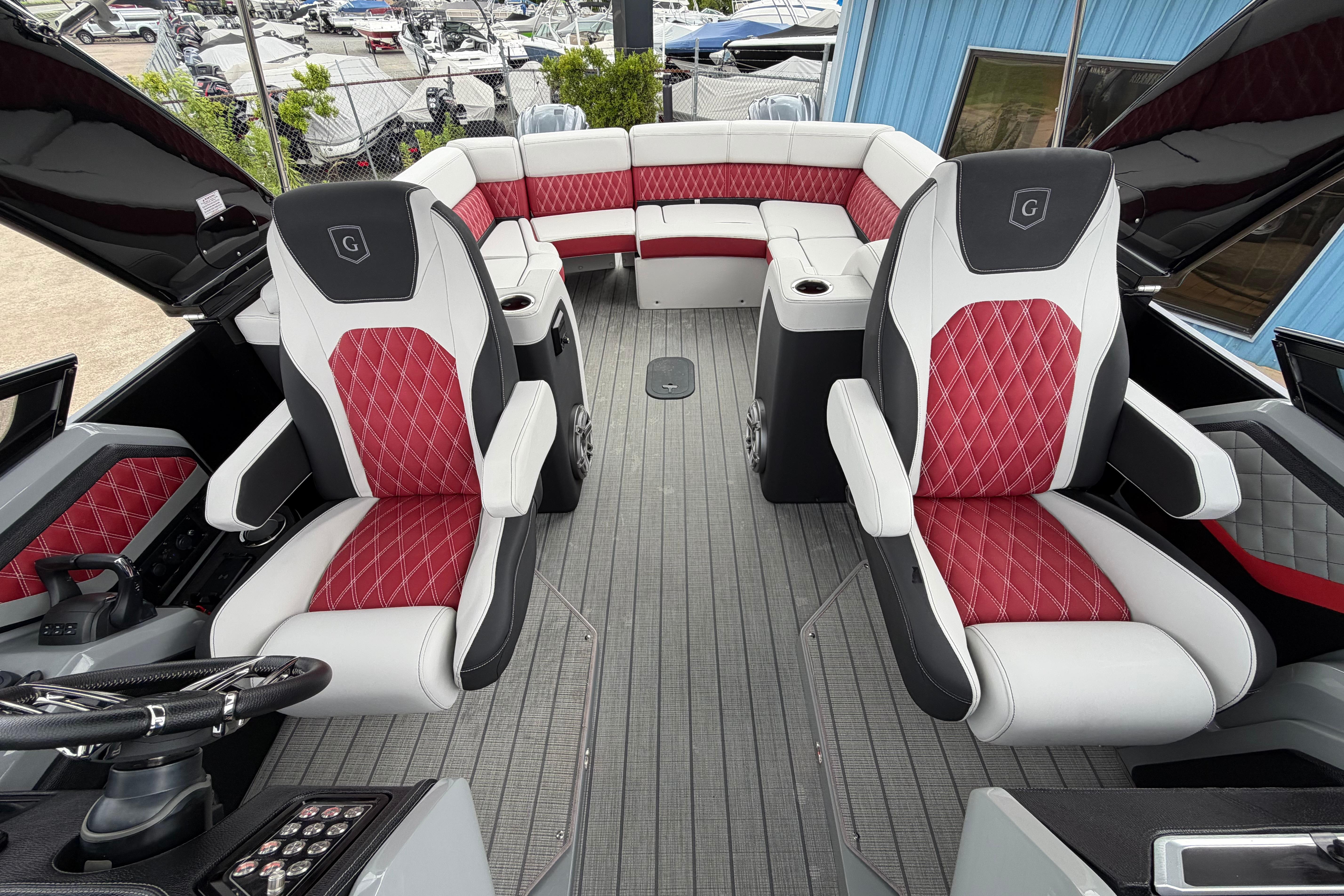 Luxury interior of 2023 Godfrey Sanpan 2700 ULW Twin pontoon boat with red and white seating.