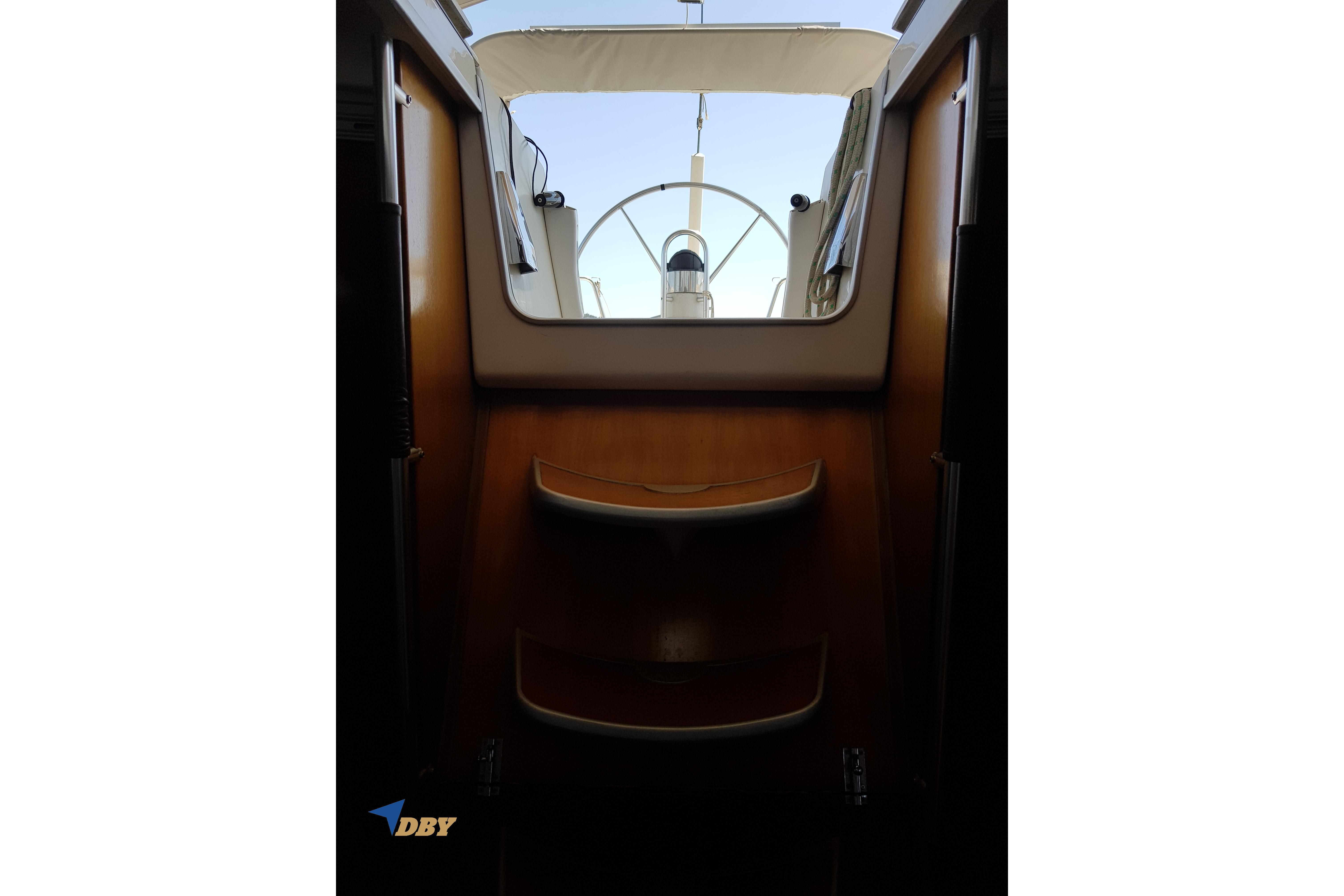 Interior view of 1993 Beneteau First 45f5 yacht, showcasing wooden steps and cockpit entrance.