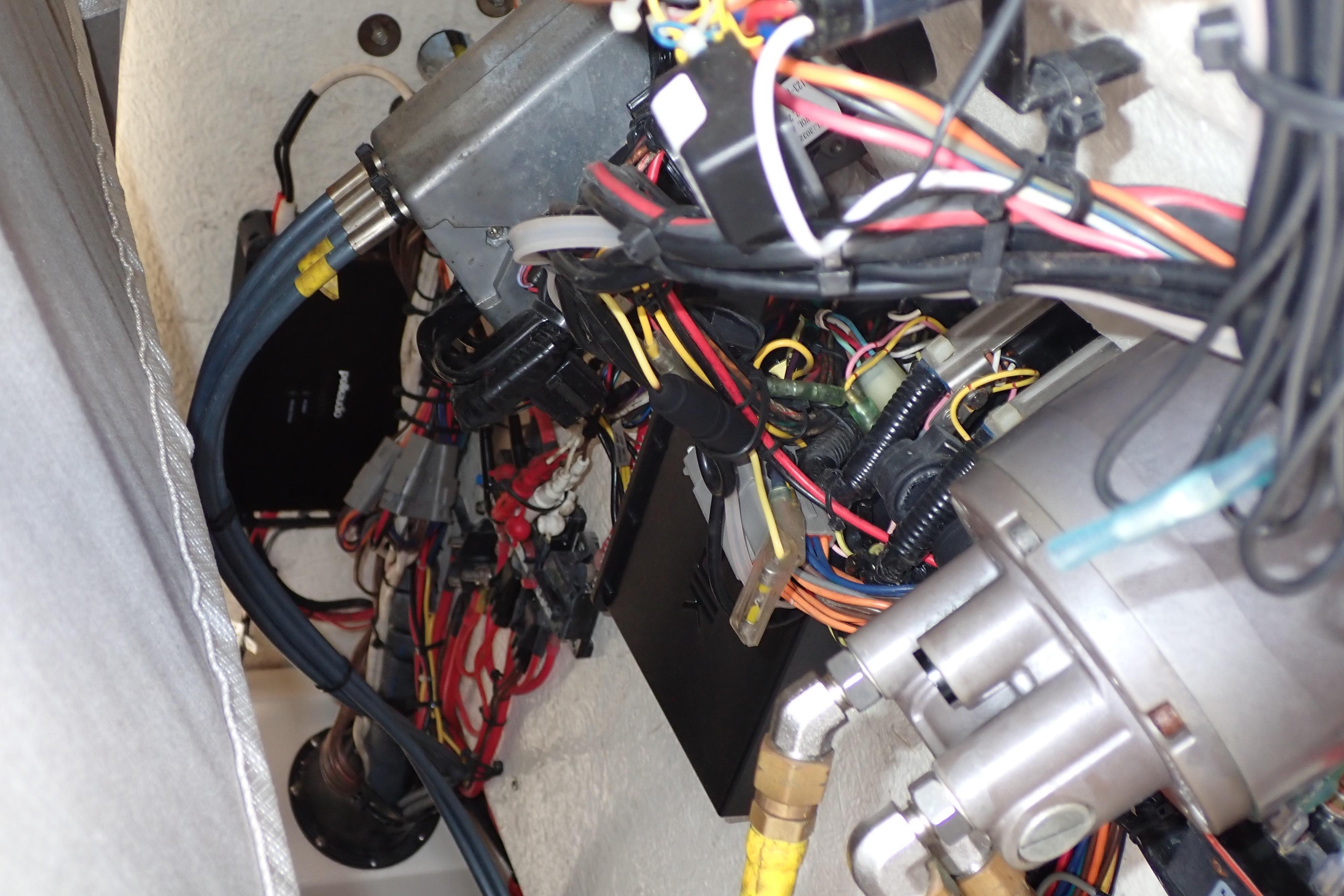 Wiring and components inside a 2019 Key West 263 FS boat, showcasing intricate electrical systems.