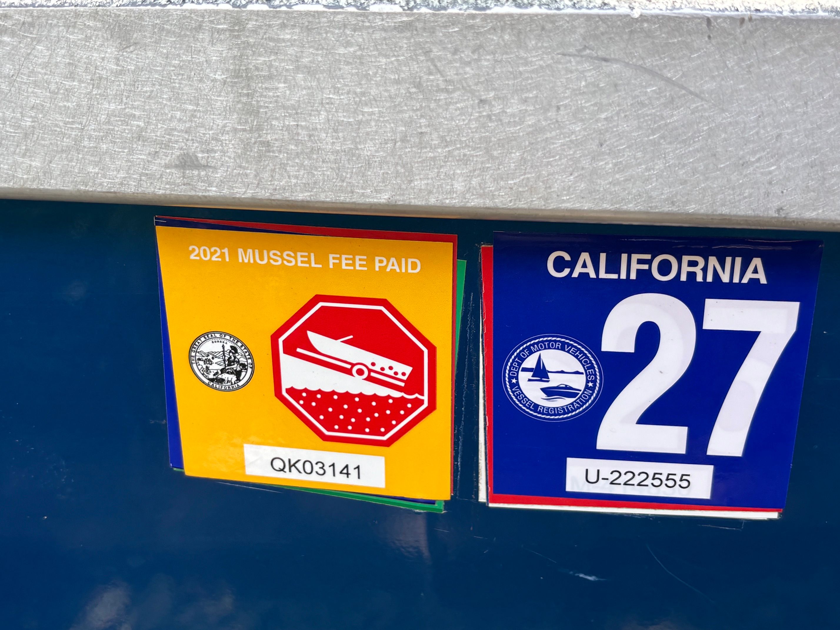 Mussel fee and California registration stickers on a boat.