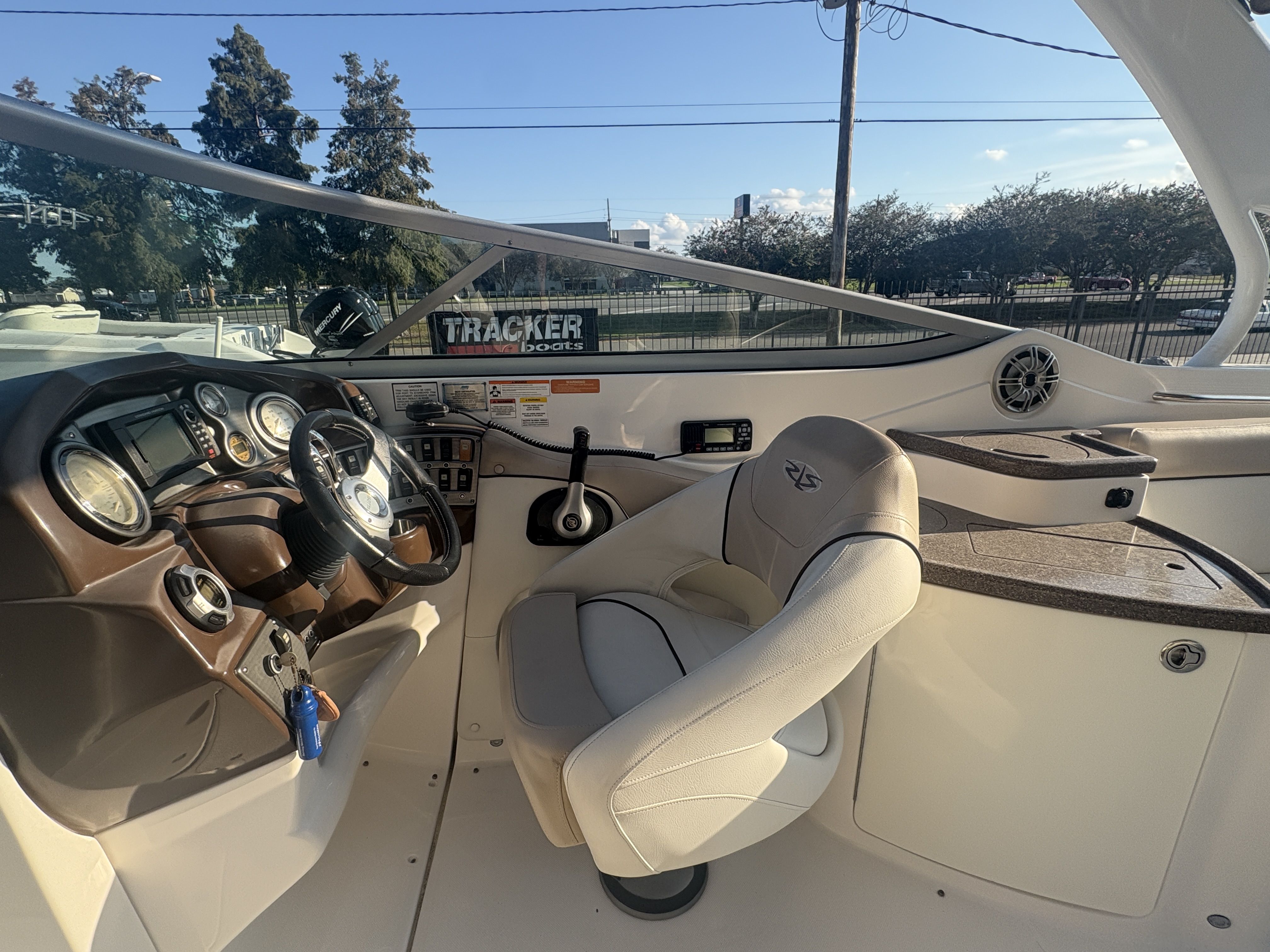 2013 Rinker Captiva 276 boat cockpit with steering wheel and control panel.