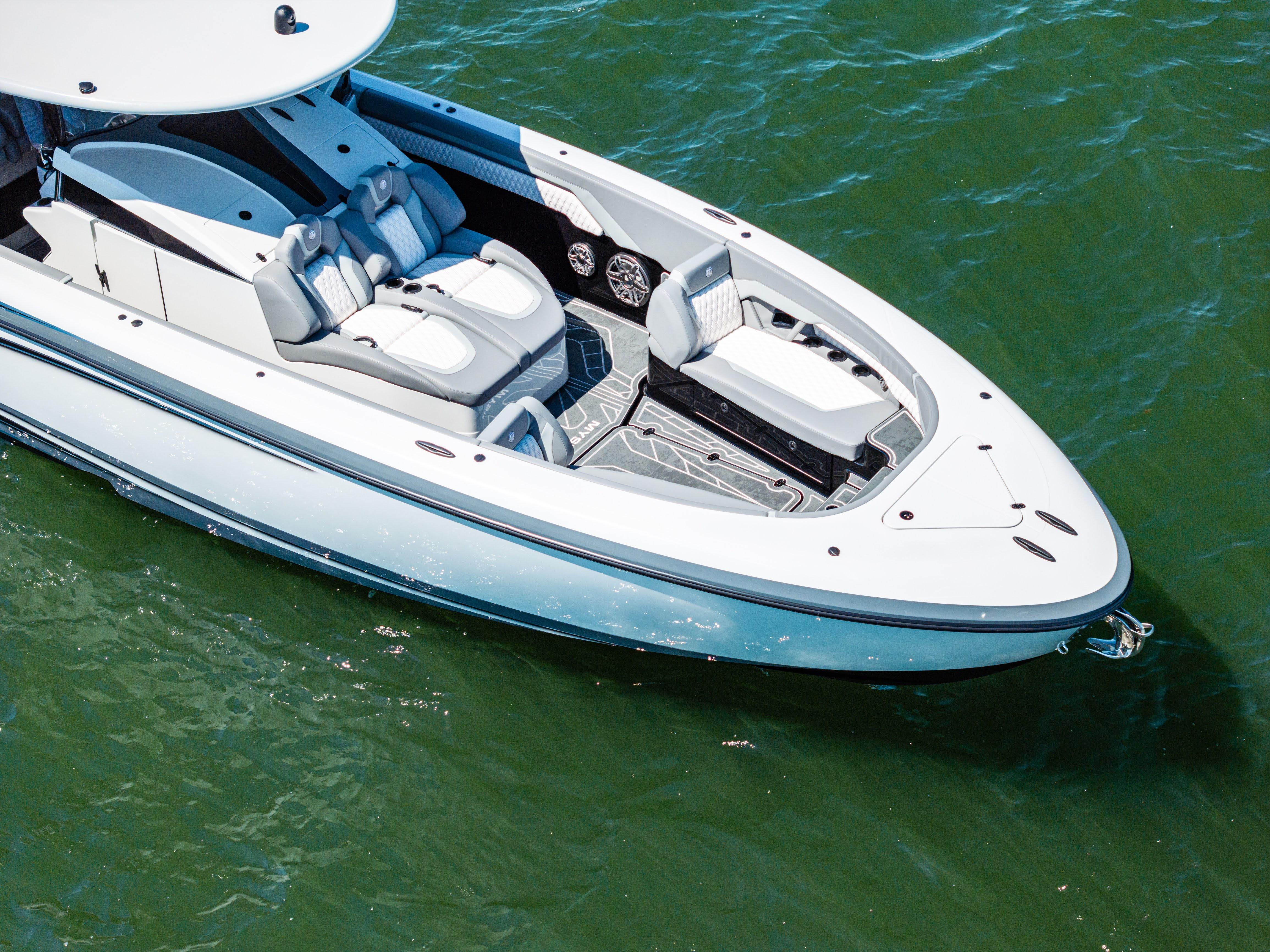 2026 Mystic Powerboats M4200 on water, showcasing sleek design and luxurious seating.