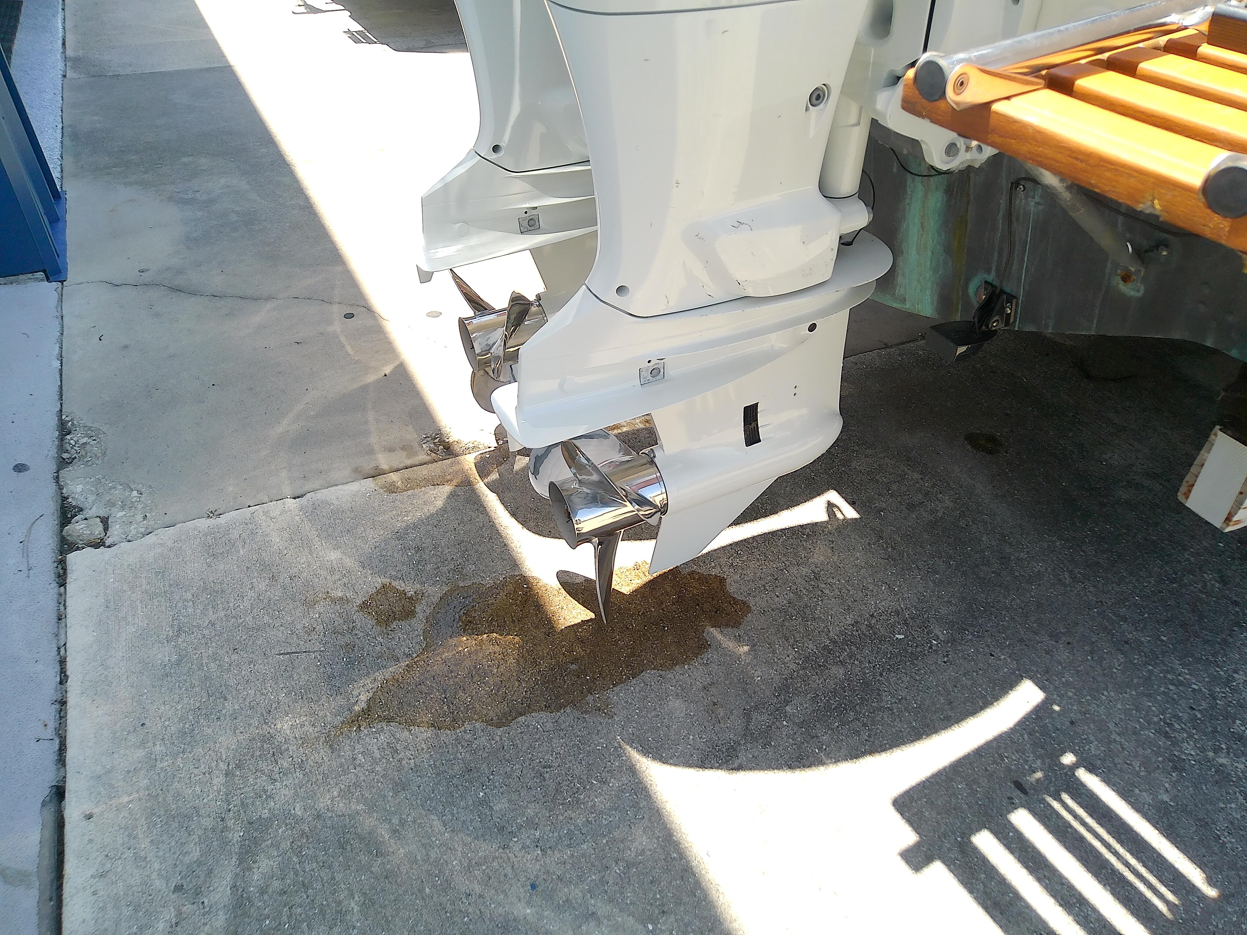 1985 Robalo 2520 Center Console boat with dual outboard motors on concrete surface.