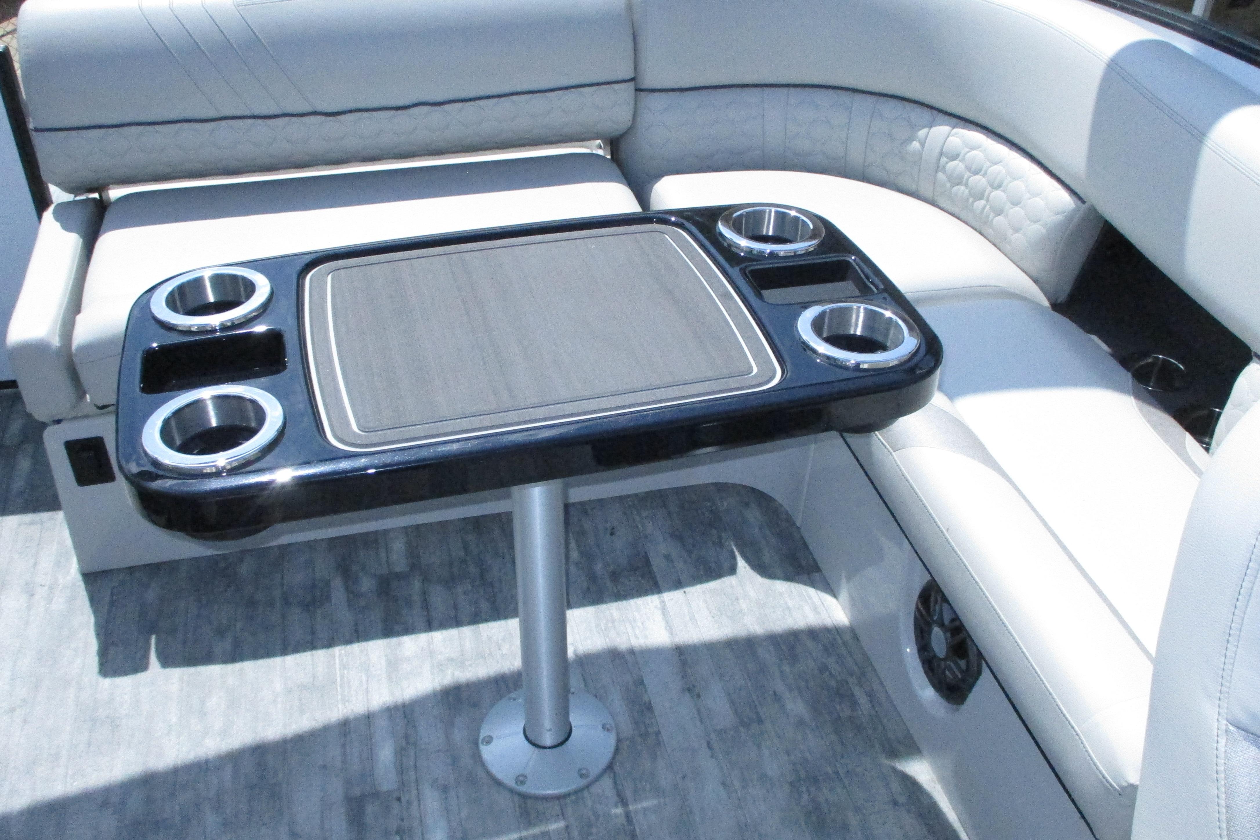 Luxurious seating area with table on 2021 Crest Caribbean LX 250 SLS boat.